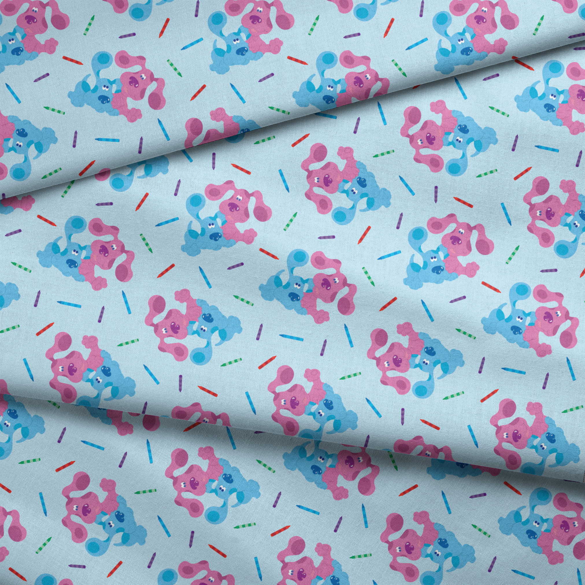 Playful pattern of cartoon blue and pink dogs with colorful stick accents on light blue background fabric fold mockup