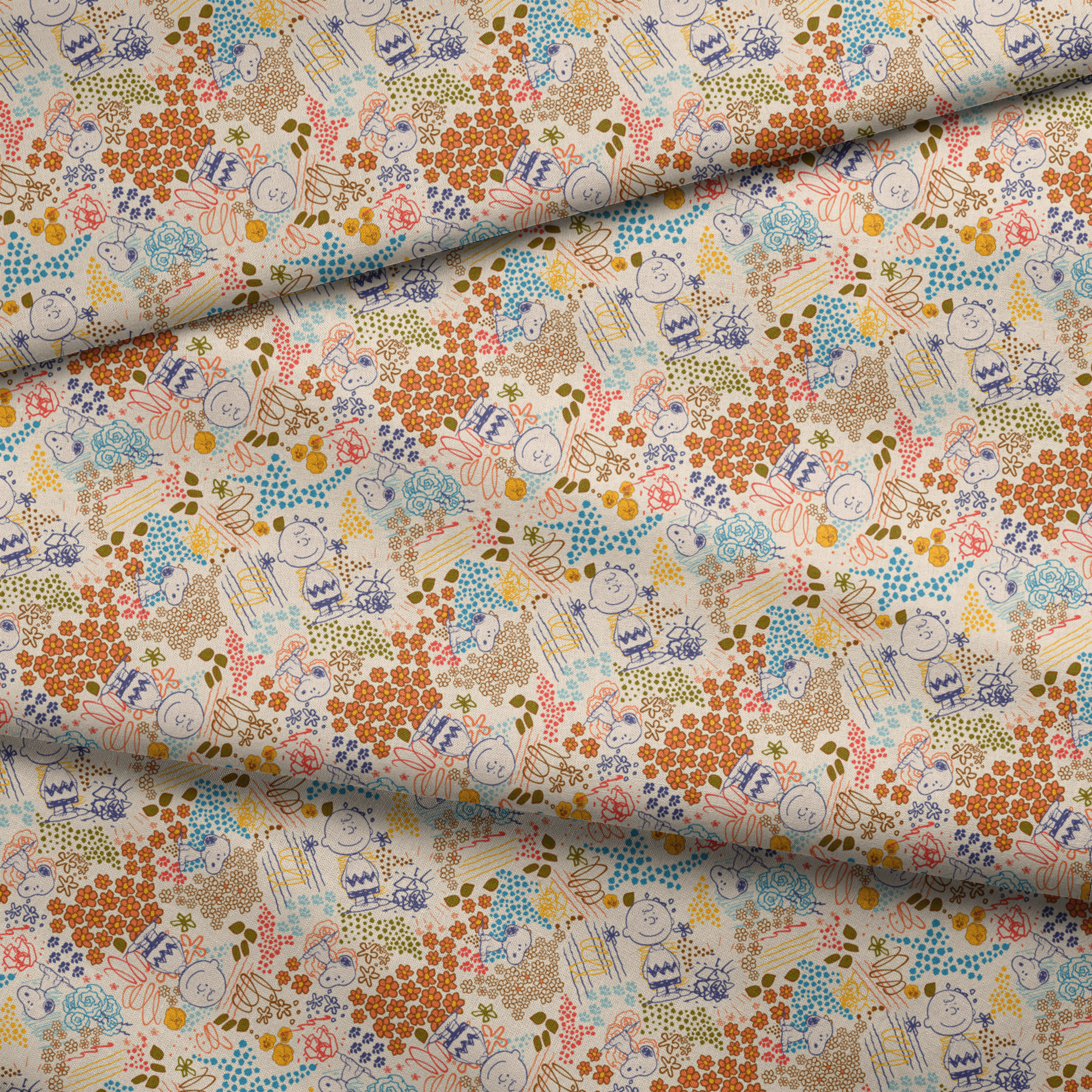Colorful pattern with Peanuts characters sketches, floral designs, and dots in orange, blue, yellow, and green on a cream background fabric fold mockup