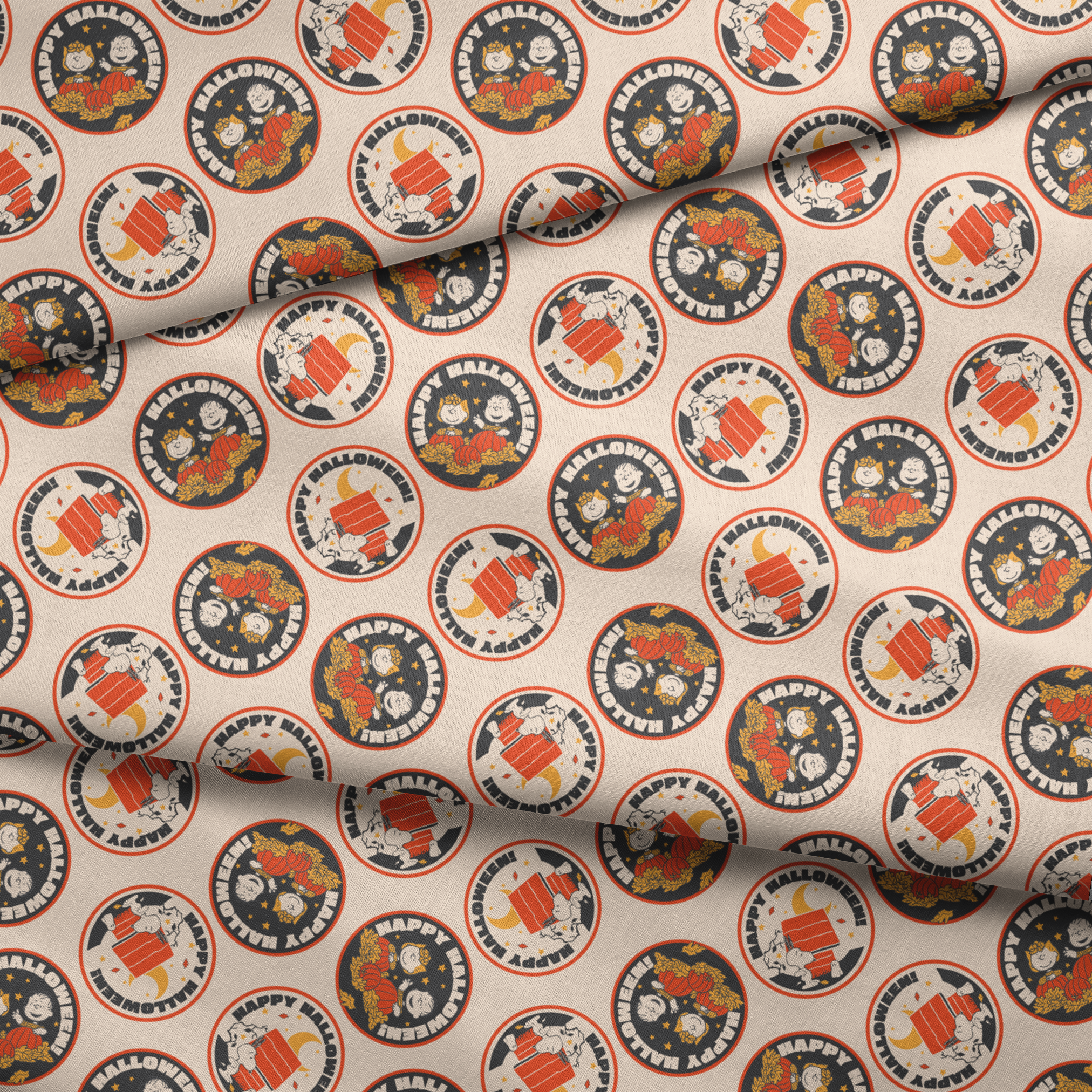 Peanuts Halloween pattern with circular badges featuring characters and "Happy Halloween" text on beige background fabric fold mockup