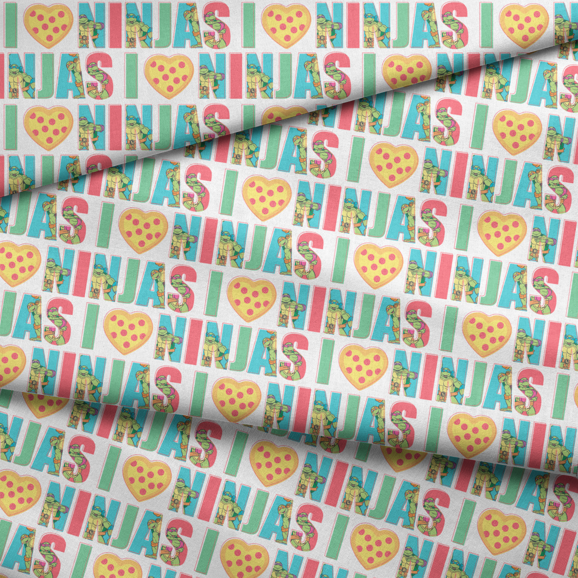 Teenage Mutant Ninja Turtles design with “I heart Ninjas” text with a pizza heart graphic, and Michelangelo and Leonardo in pastel colors. fabric fold mockup