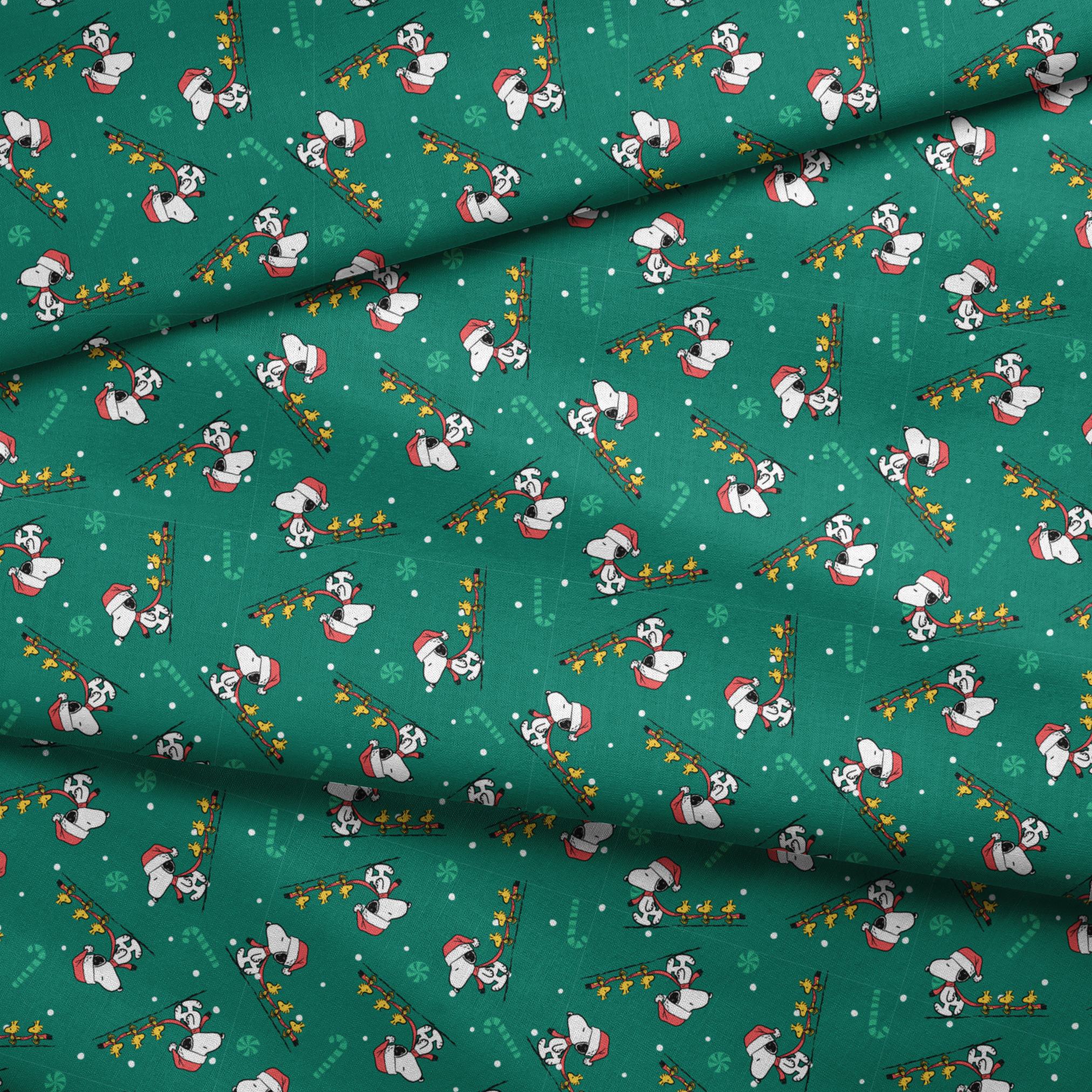 Holiday pattern with Snoopy in Santa hats pulling sleds of stars on green background with candy canes and snowflakes fabric fold mockup