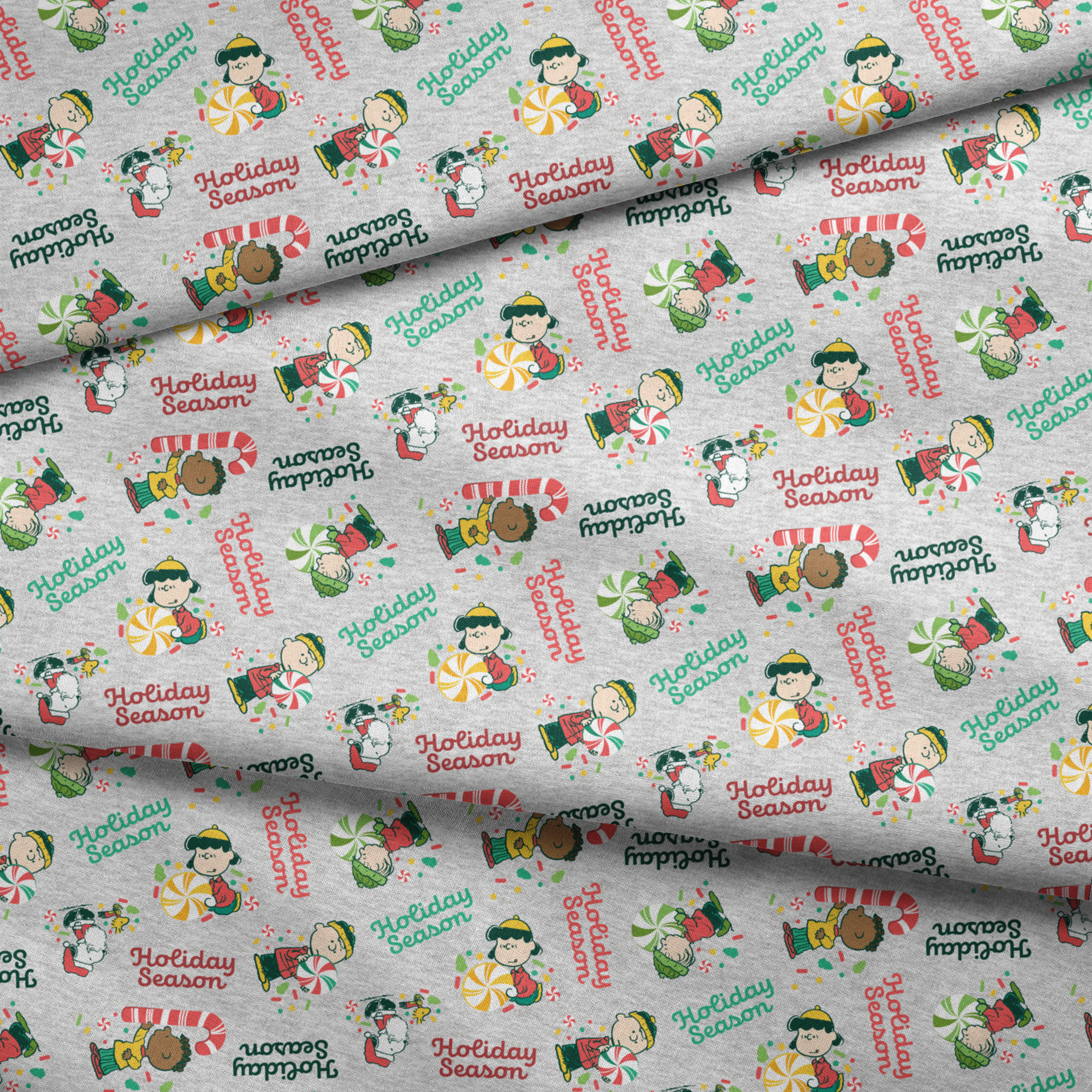 Festive Peanuts characters with candy canes and peppermints on gray background with "Holiday Season" text fabric fold mockup