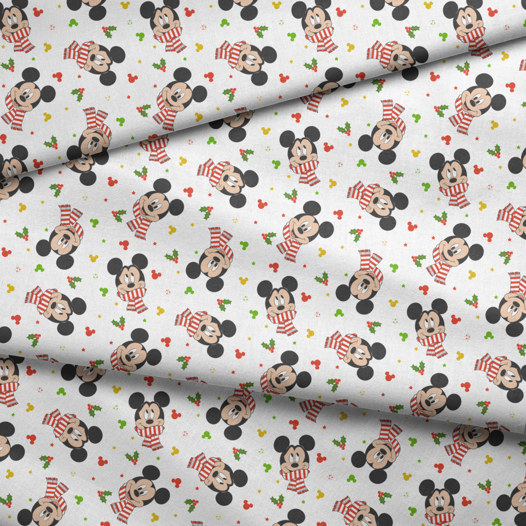 Mickey Mouse wearing red striped scarves, surrounded by holly and colorful icons on white background fabric fold mockup