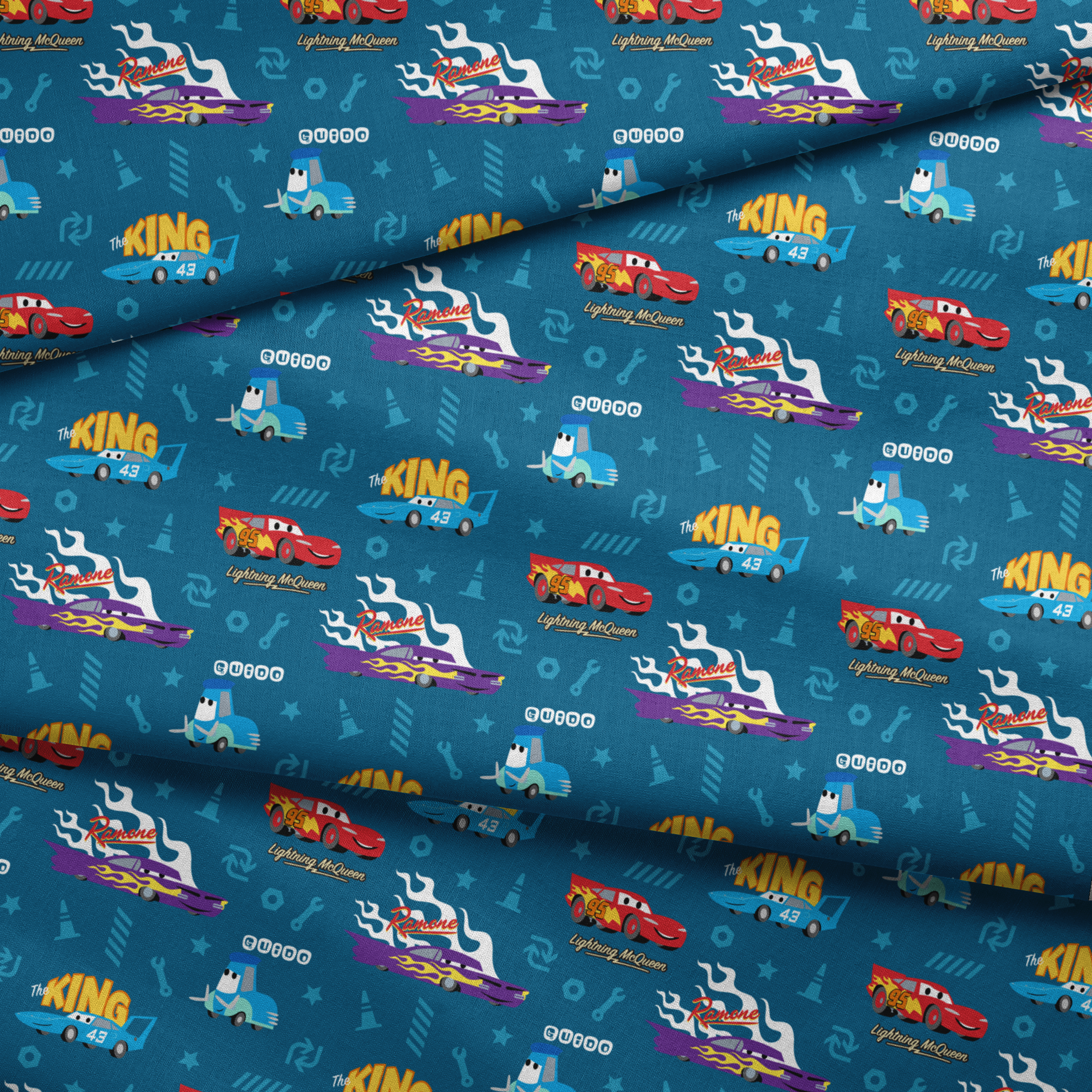 Disney Cars pattern featuring Lightning McQueen, Ramone's purple car with flames, and The King 43 on blue background with racing icons fabric fold mockup