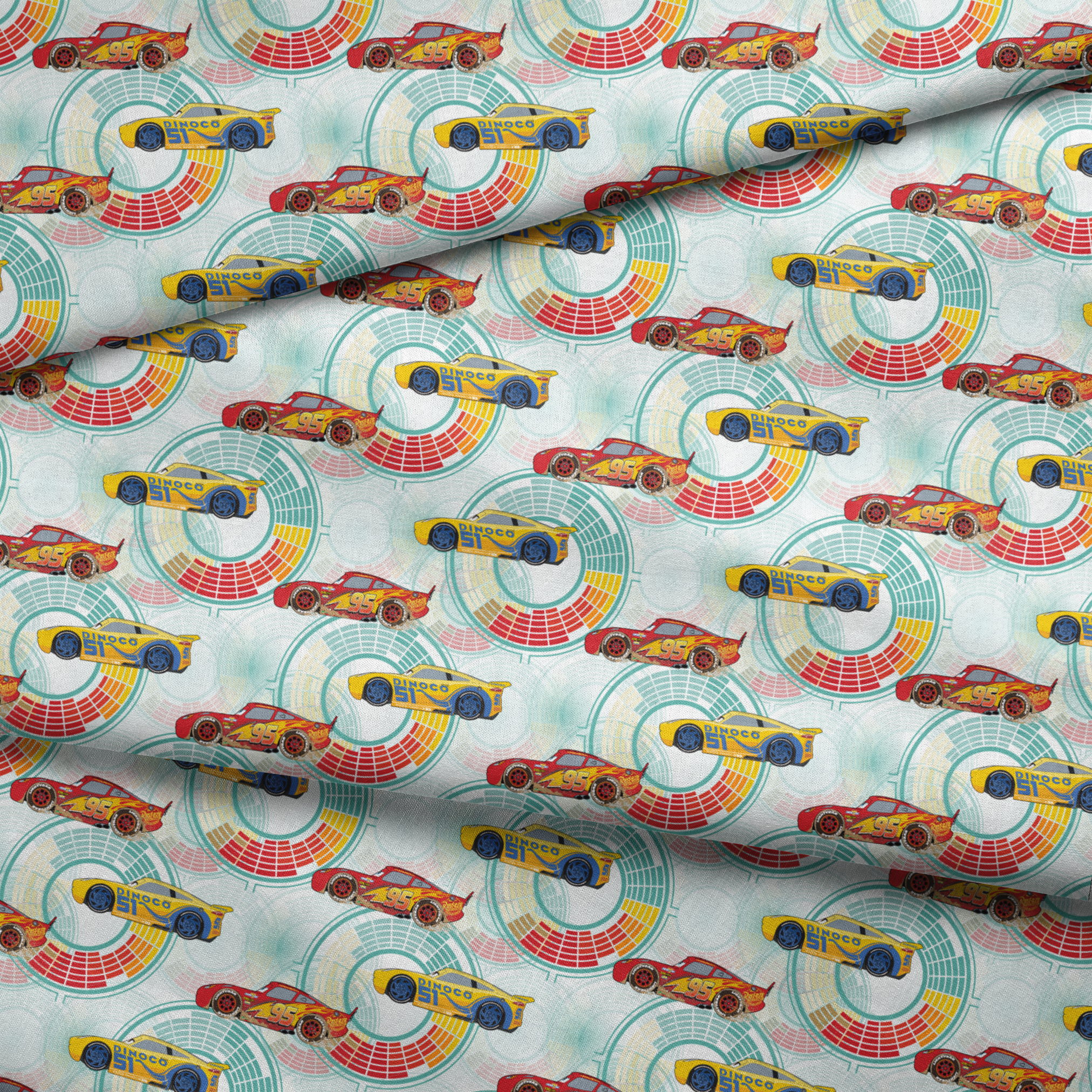 Colorful Disney Pixar Cars racing in red and yellow on a light blue background with circular patterns fabric fold mockup