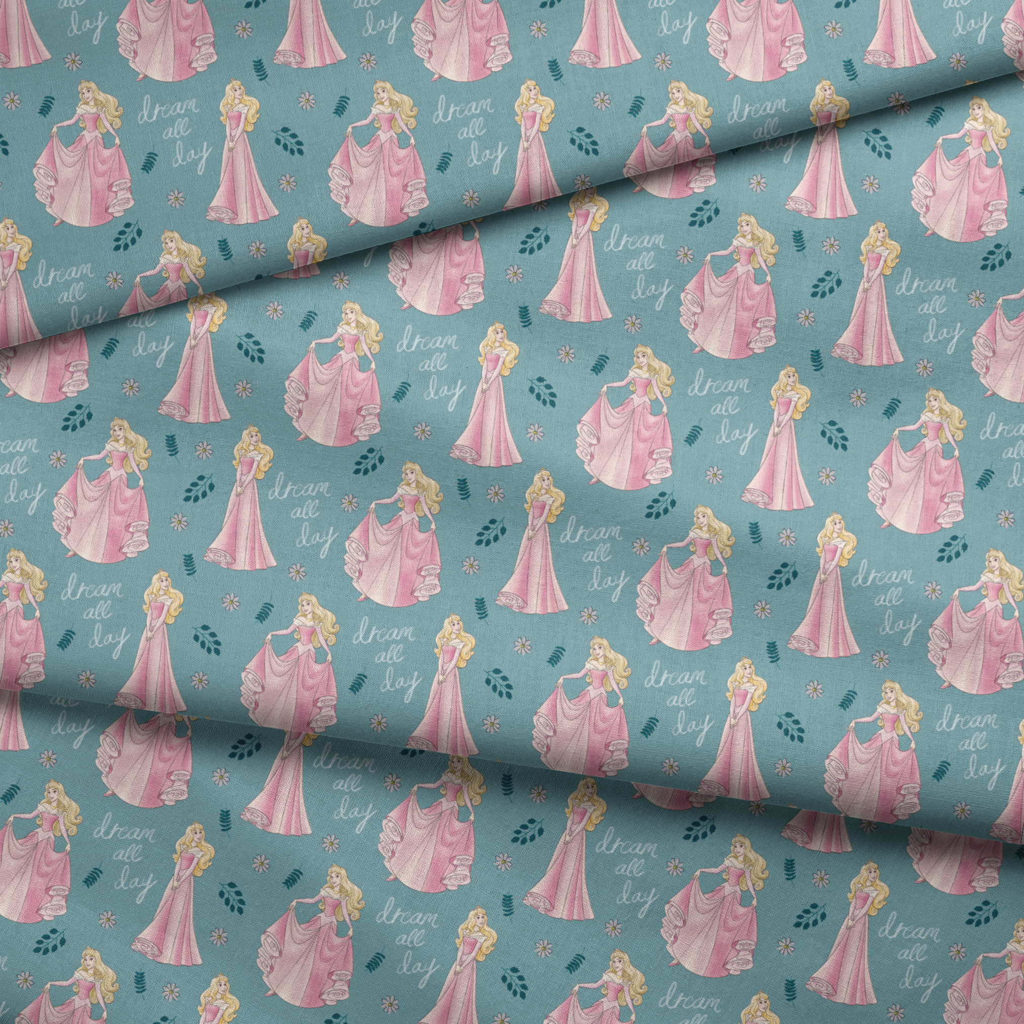 Sleeping Beauty pattern with "dream all day" text on teal background with floral elements fabric fold mockup