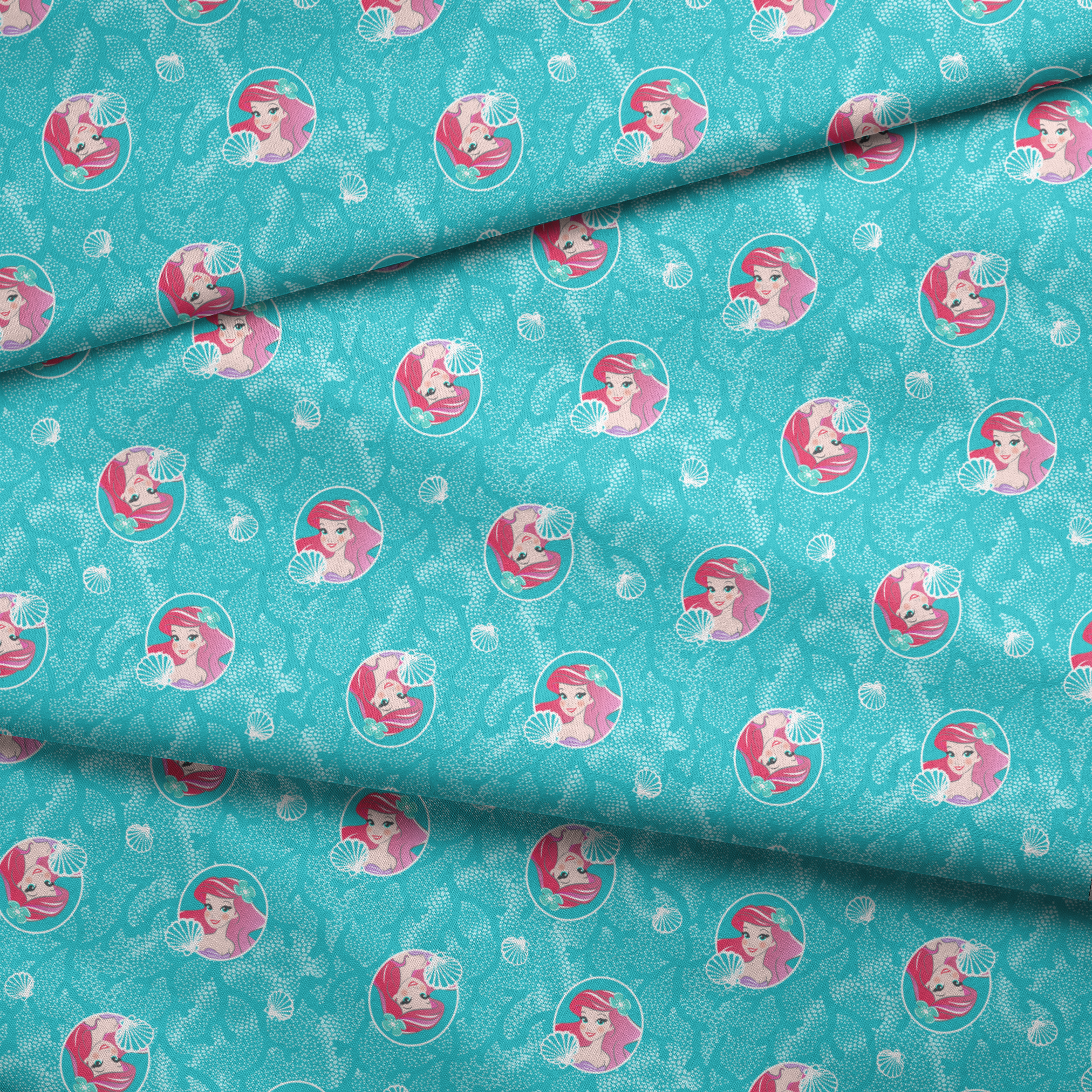 The Little Mermaid pattern with Ariel in turquoise circles on aqua background with seashells fabric fold mockup