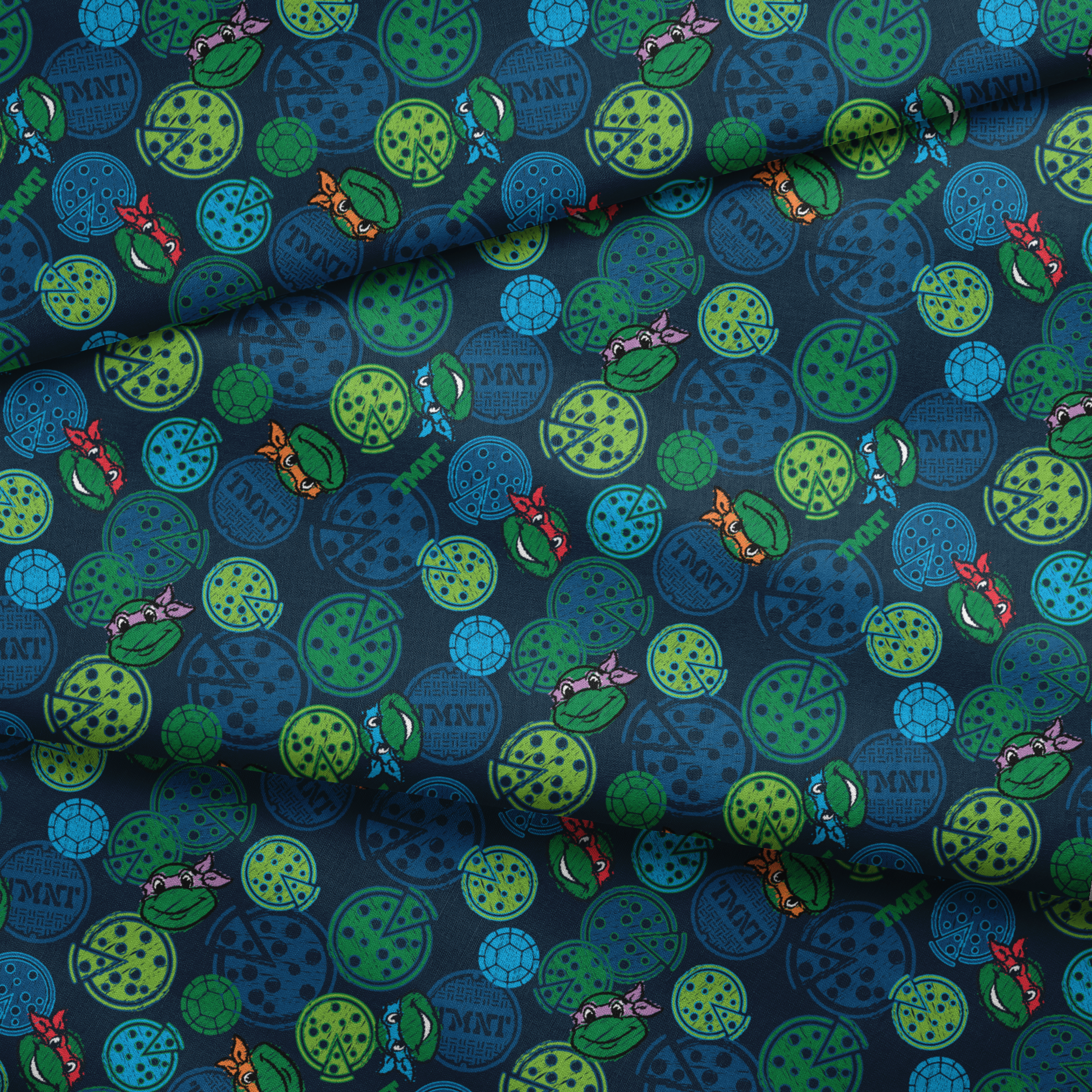 Teenage Mutant Ninja Turtles pattern with cartoon character heads and green/blue pizza circles fabric fold mockup