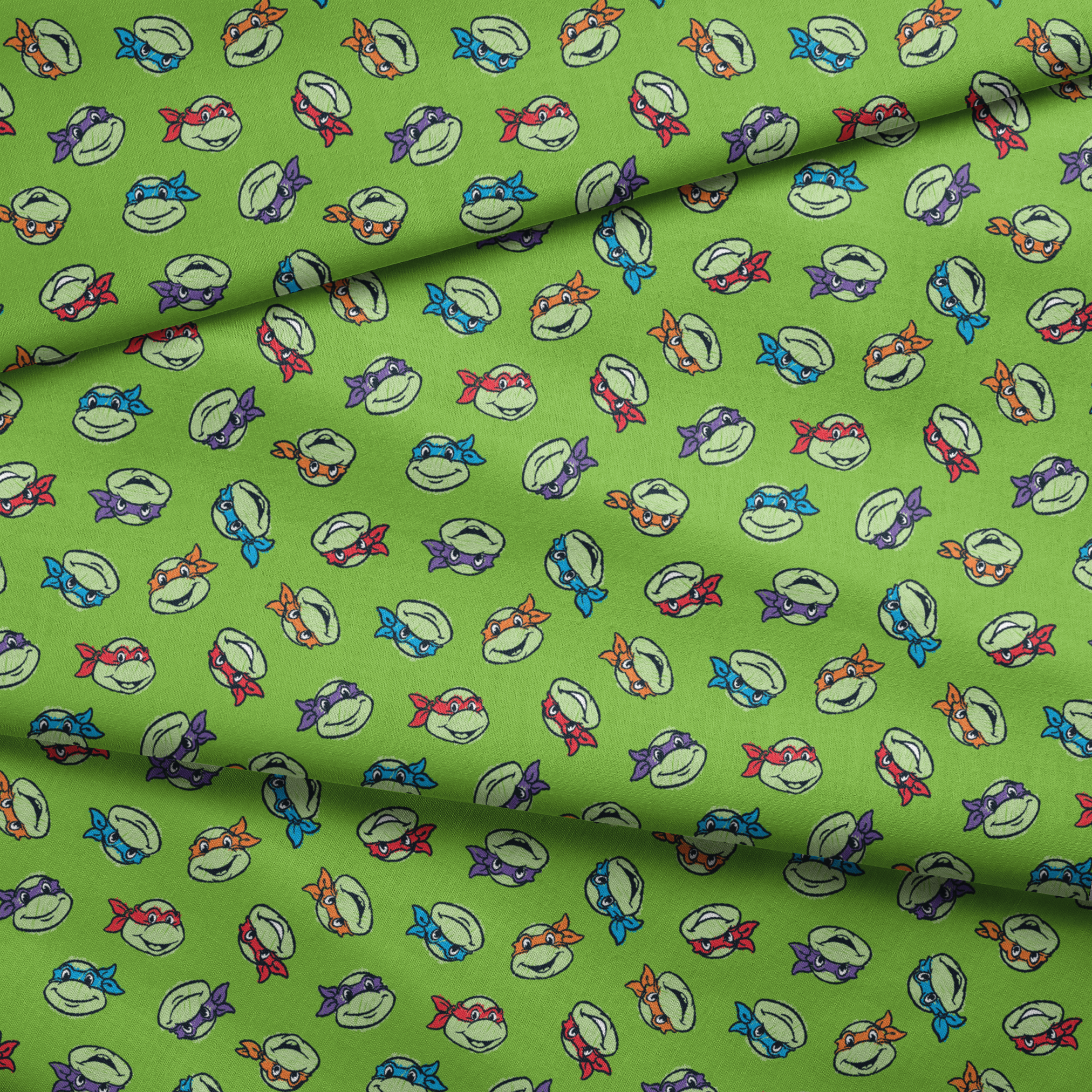 Teenage Mutant Ninja Turtles scattered on bright green background fabric fold mockup