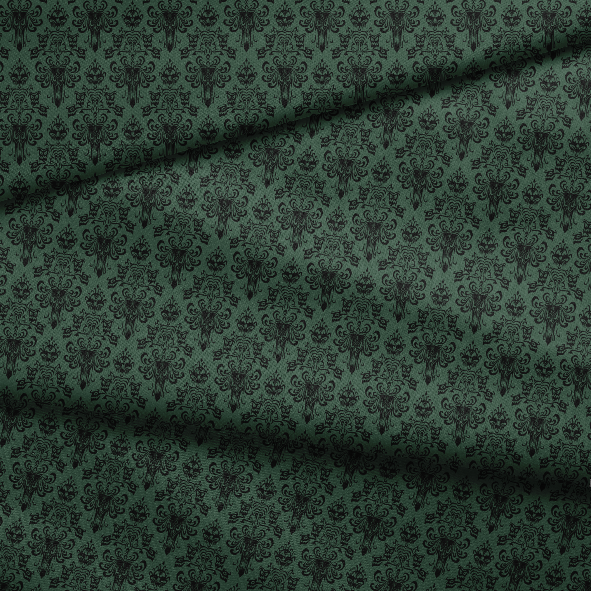 The image shows an elegant Victorian or Gothic-style damask pattern in black against a dark green background. The repeating ornate design features intricate scrollwork, flourishes, and symmetrical decorative elements arranged in a traditional wallpaper or textile pattern style. fabric fold mockup