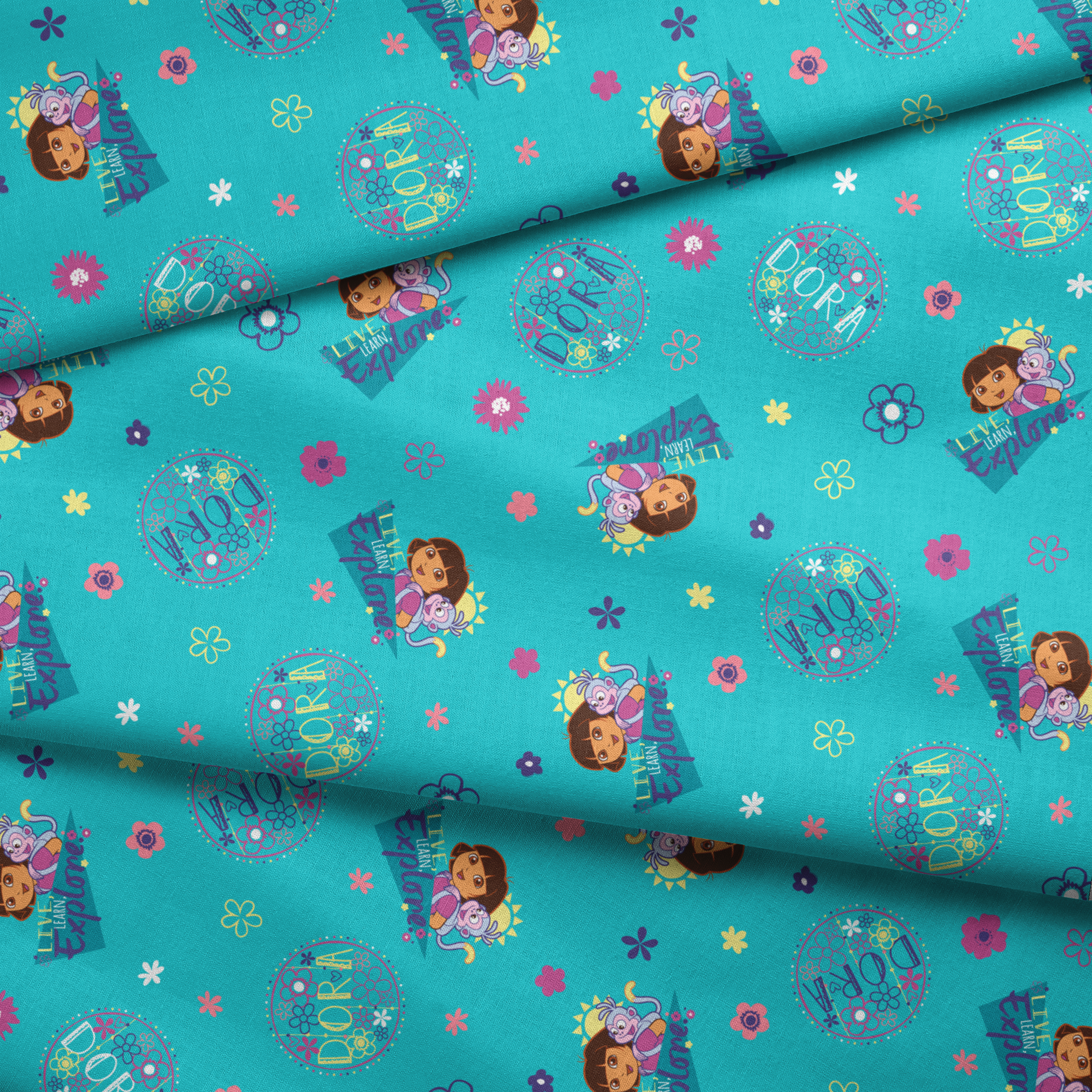 Colorful teal pattern with Dora the Explorer characters, decorative circles, flowers, and triangular shapes in pink, purple, and blue fabric fold mockup