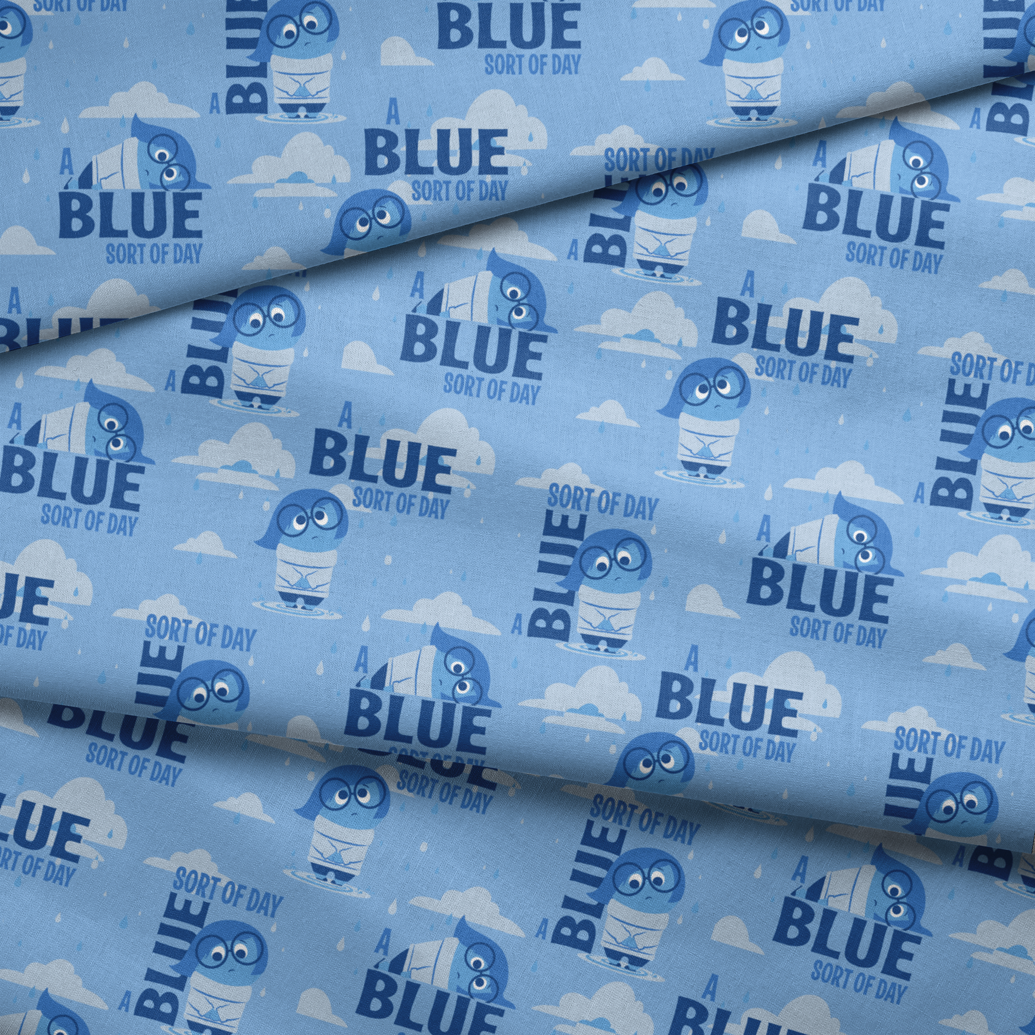 Sadness from Disney and Pixar's Inside Out pattern with "BLUE SORT OF DAY" text on light blue background with clouds fabric fold mockup