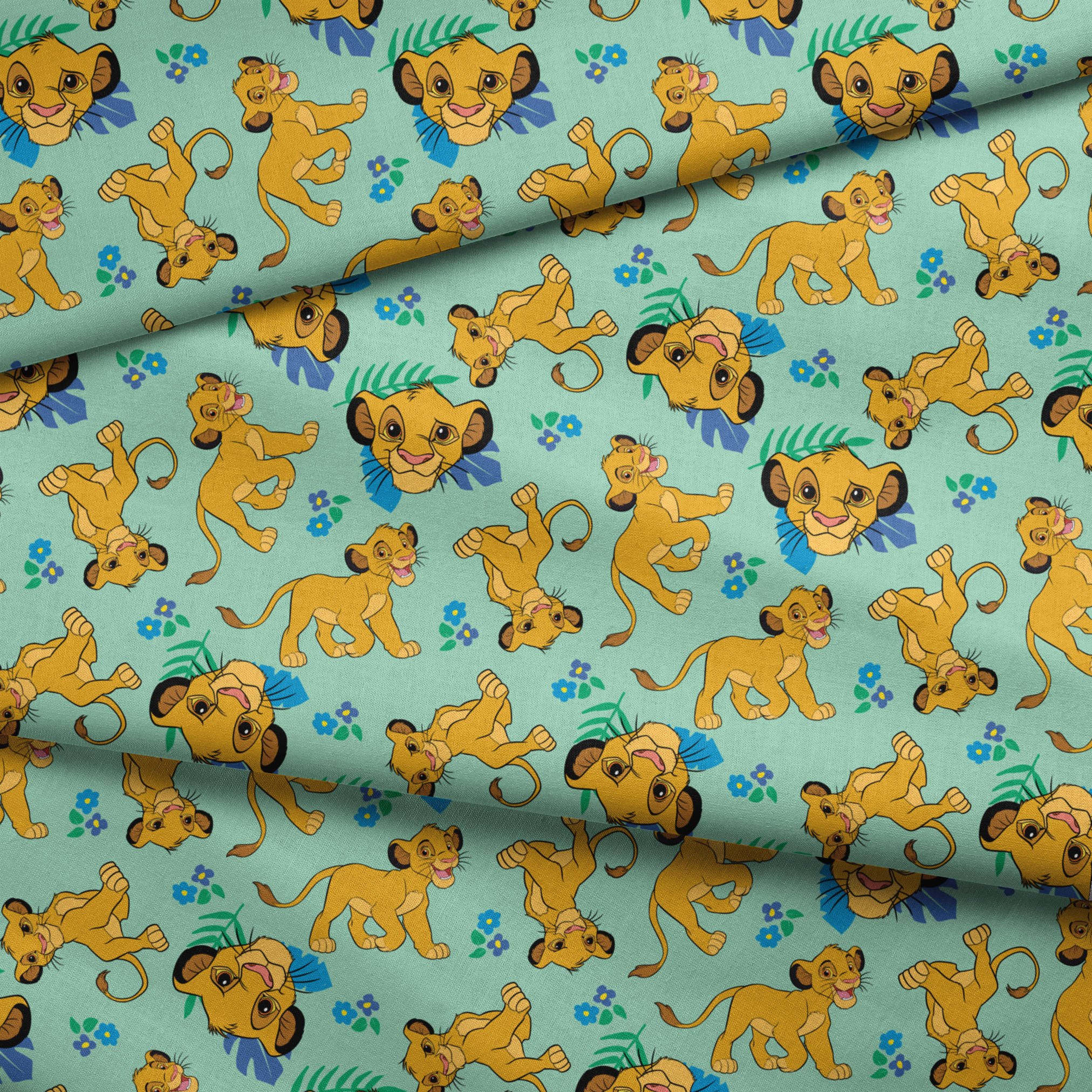 Cartoon lion cubs playing on mint green background with blue flowers and green leaves pattern fabric fold mockup