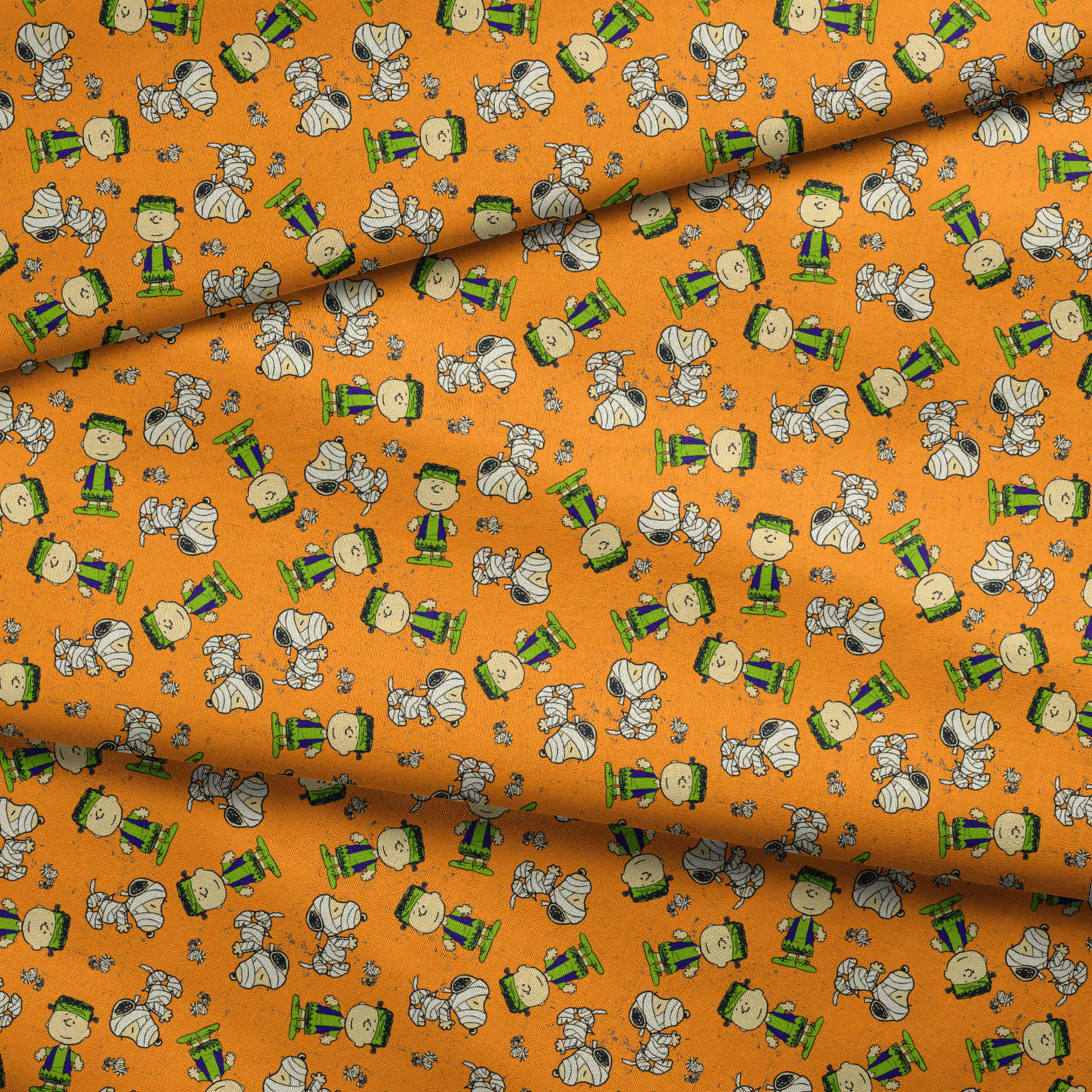 Peanuts characters pattern on orange background with Charlie Brown, Snoopy, and friends scattered throughout fabric fold mockup