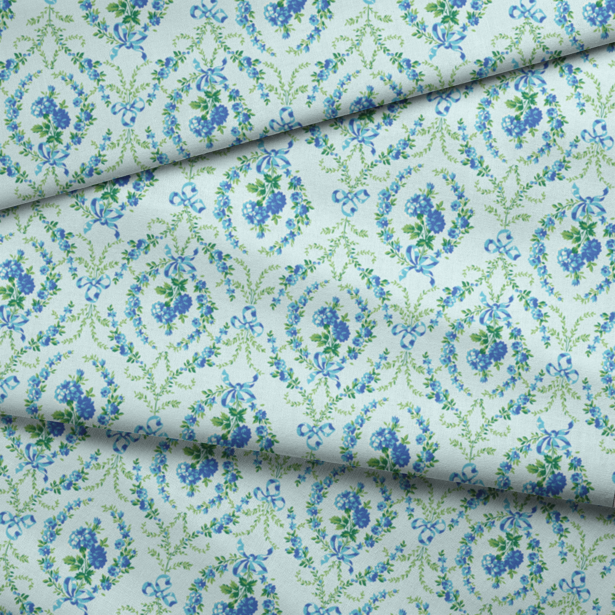 Blue floral pattern with diamond lattice design featuring delicate ribbons and green foliage on light background fabric fold mockup