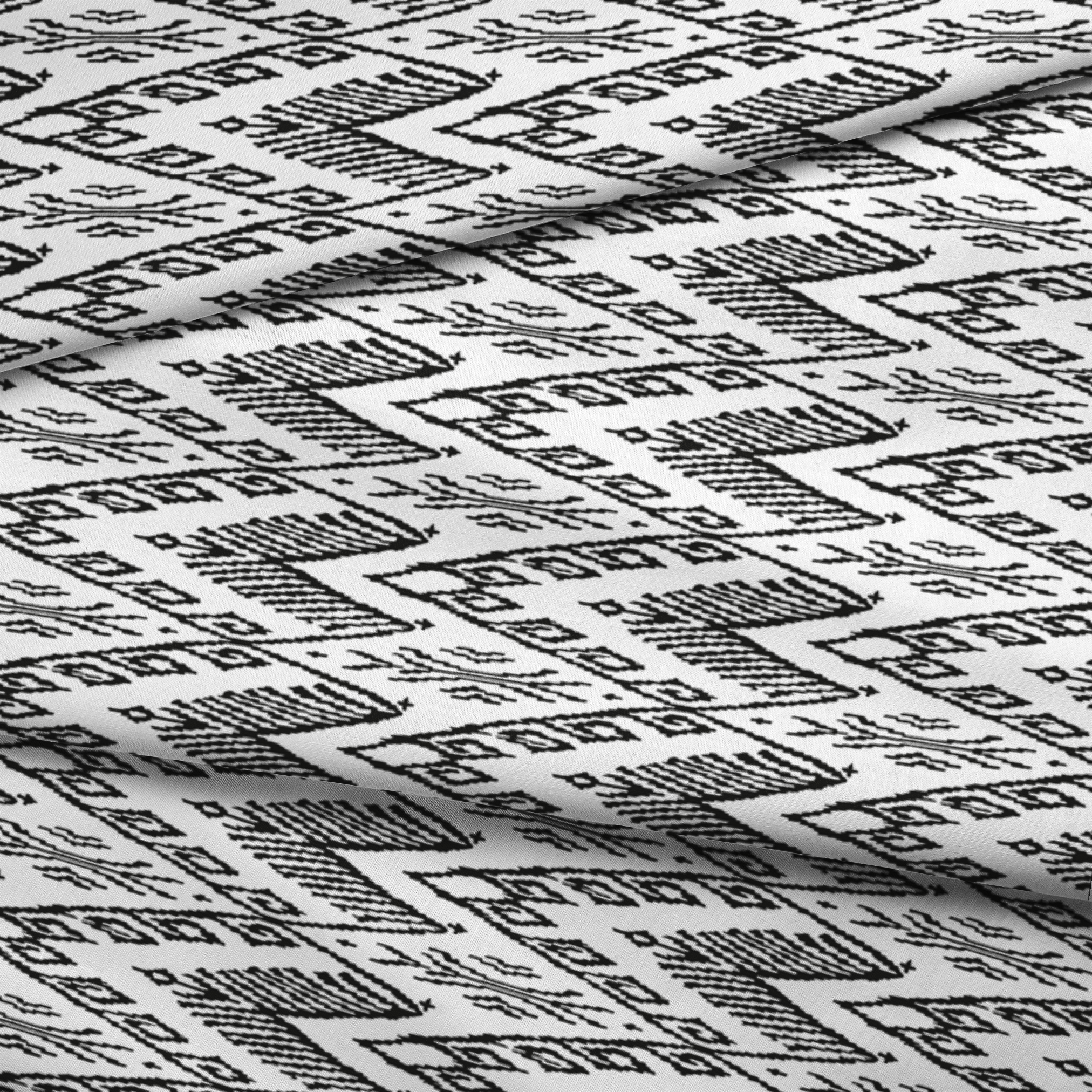 Black and white geometric pattern with diamond shapes and zigzag motifs on a textile surface fabric fold mockup