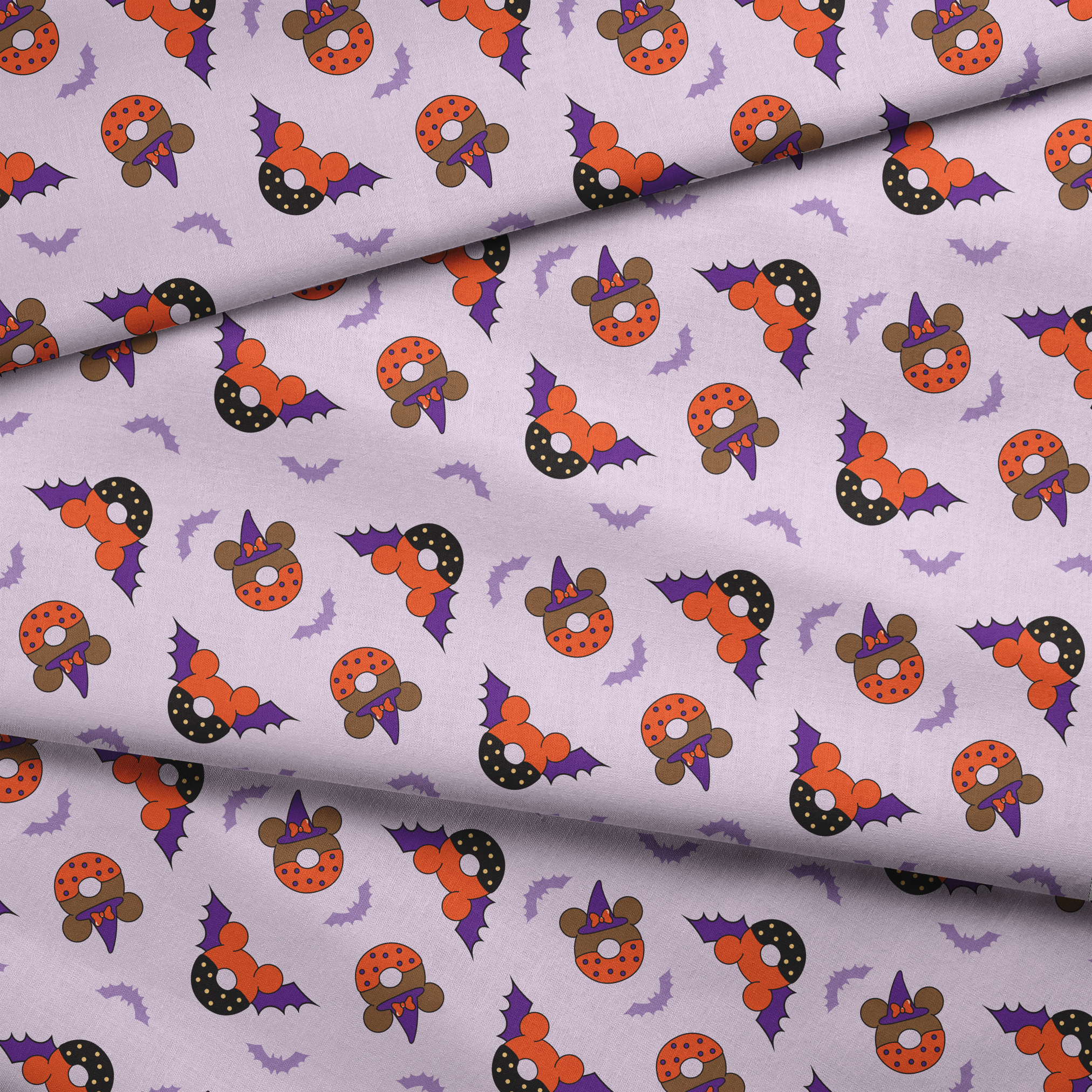 Disney Halloween-themed pattern with orange and black donuts, purple bat wings, and light purple bats on lavender background fabric fold mockup