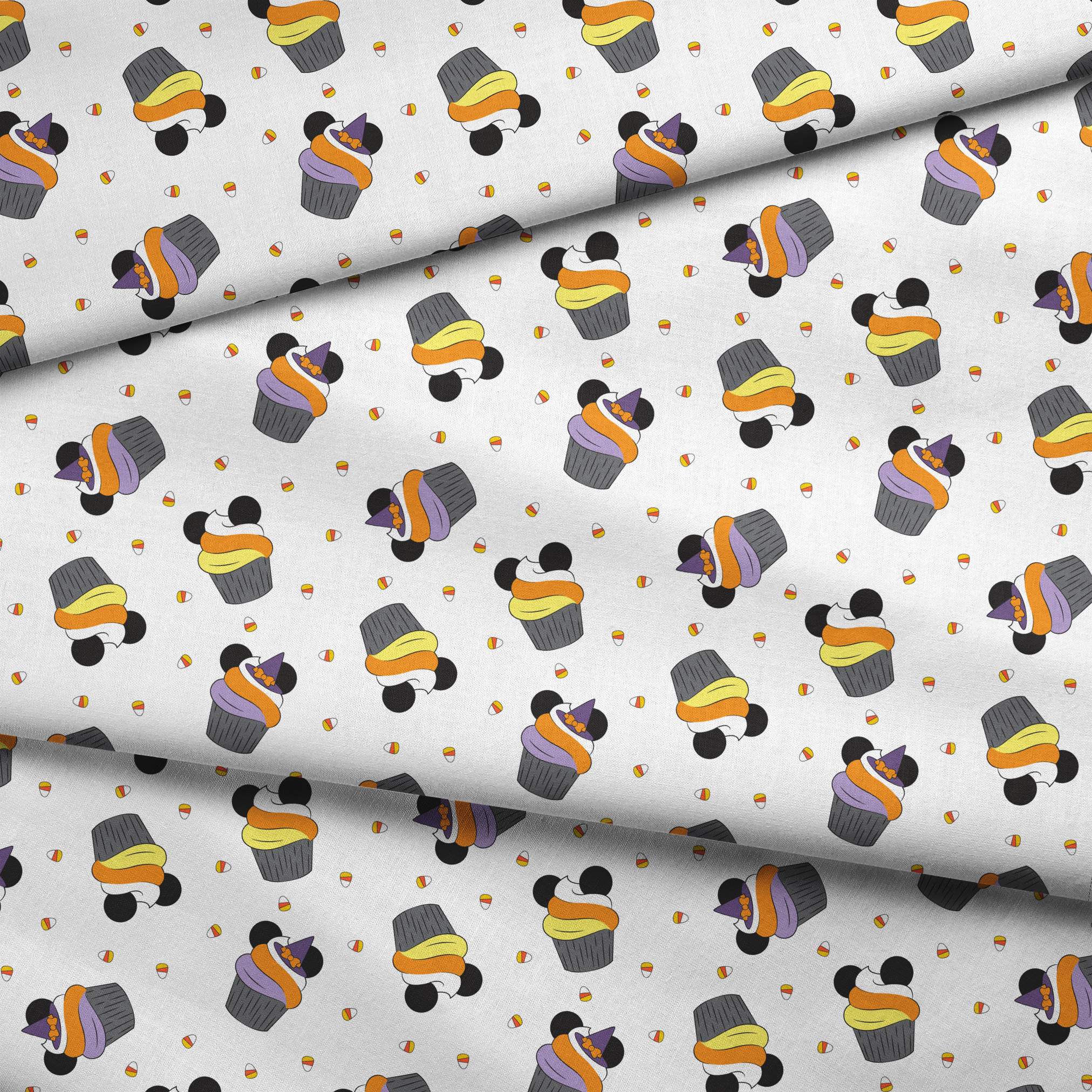 Disney cupcakes with black circular elements and colorful frosting in orange, yellow, and purple on a white background. fabric fold mockup