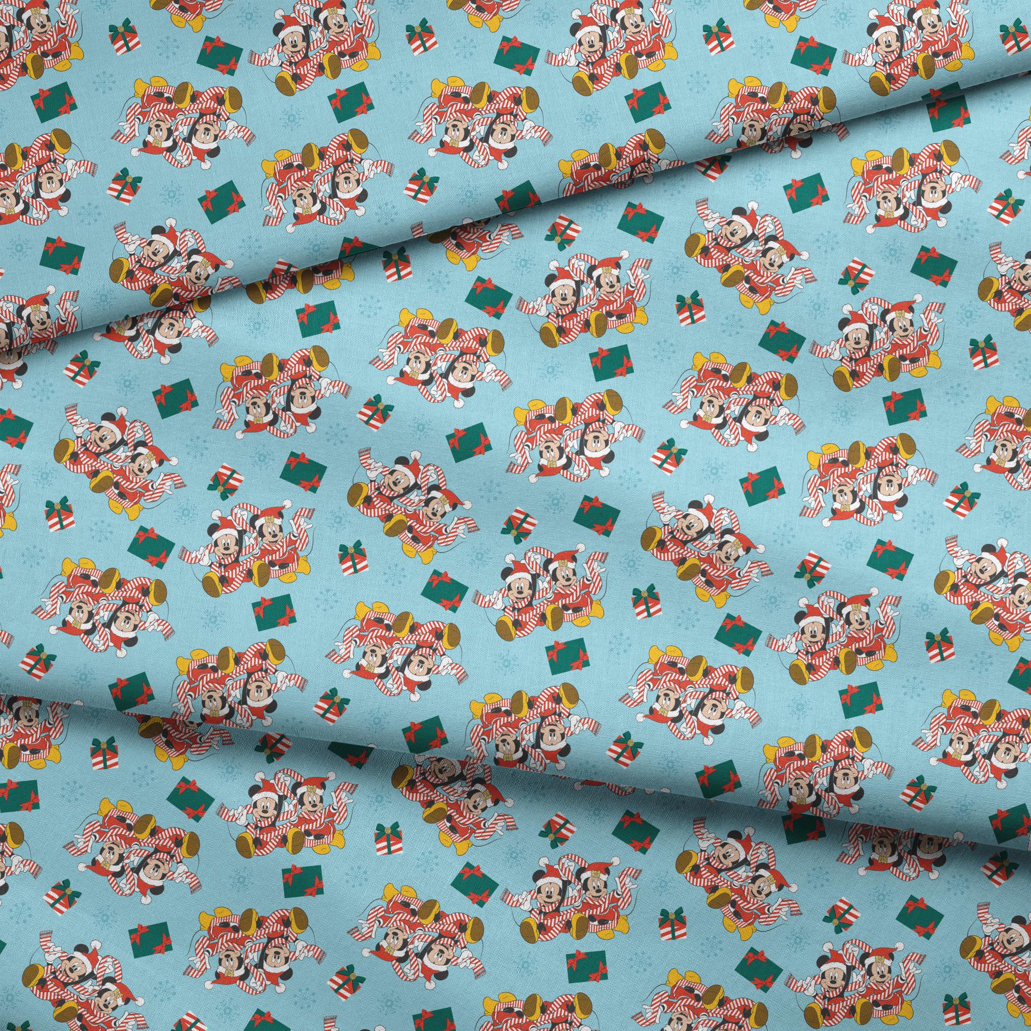 Mickey and Minnie Mouse pattern with candy stripe pajamas, presents, and snowflakes on light blue background fabric fold mockup