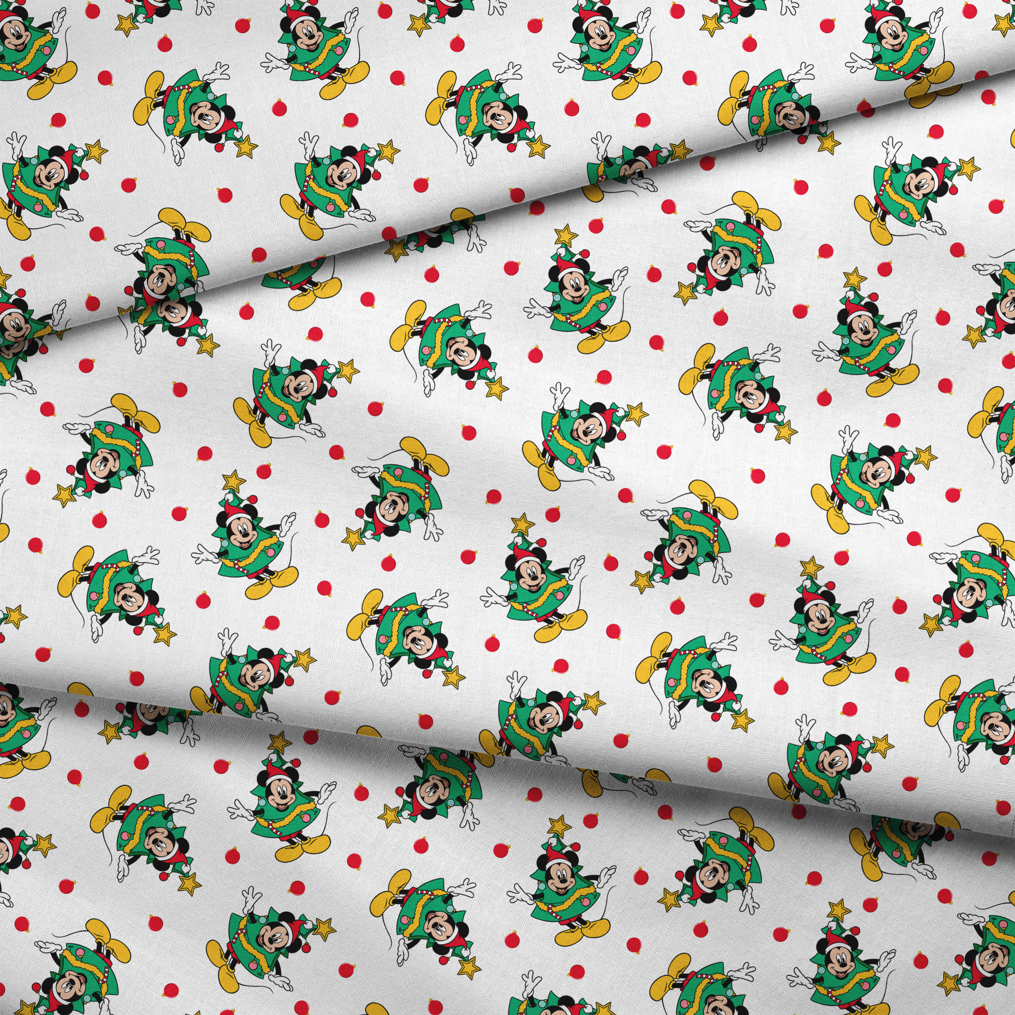 Mickey Mouse in a Christmas tree costume and stars on white background with red dots fabric fold mockup