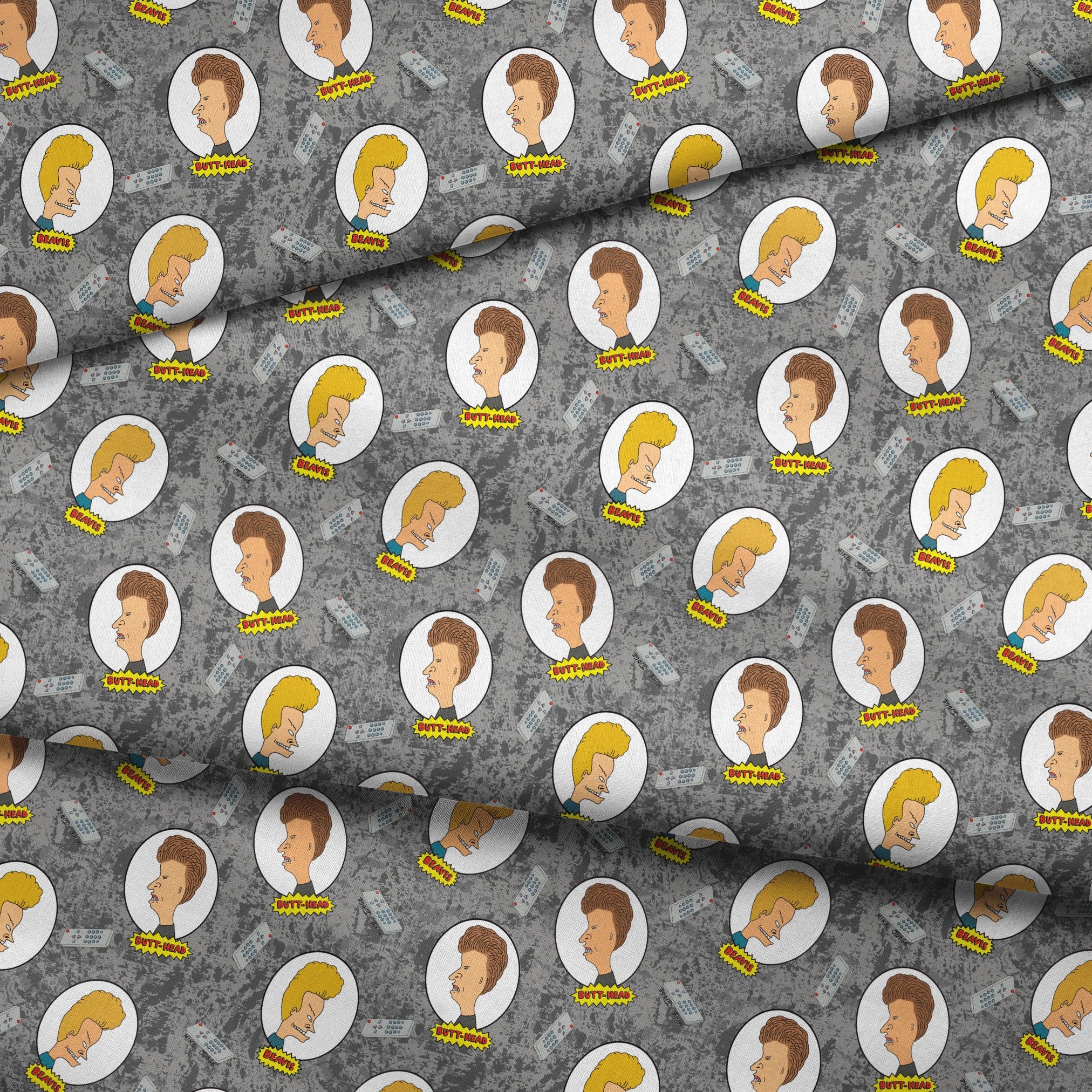 Cartoon pattern with blond and brown-haired animated characters in circular frames against a gray background with comic-style text bubbles. fabric fold mockup