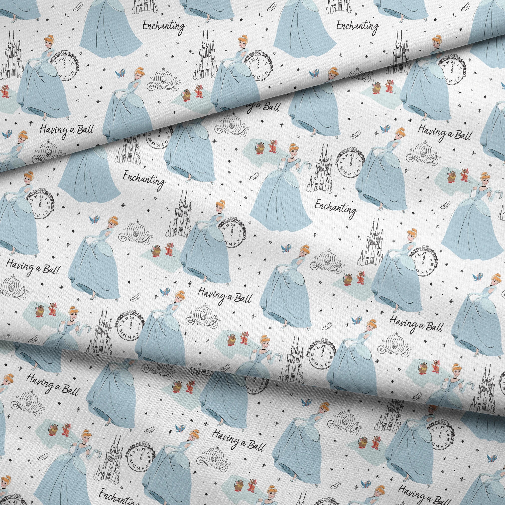 Whimsical pattern featuring cartoon princess in blue gown, clocks, castles, carriages and "Enchanting" text on white background fabric fold mockup