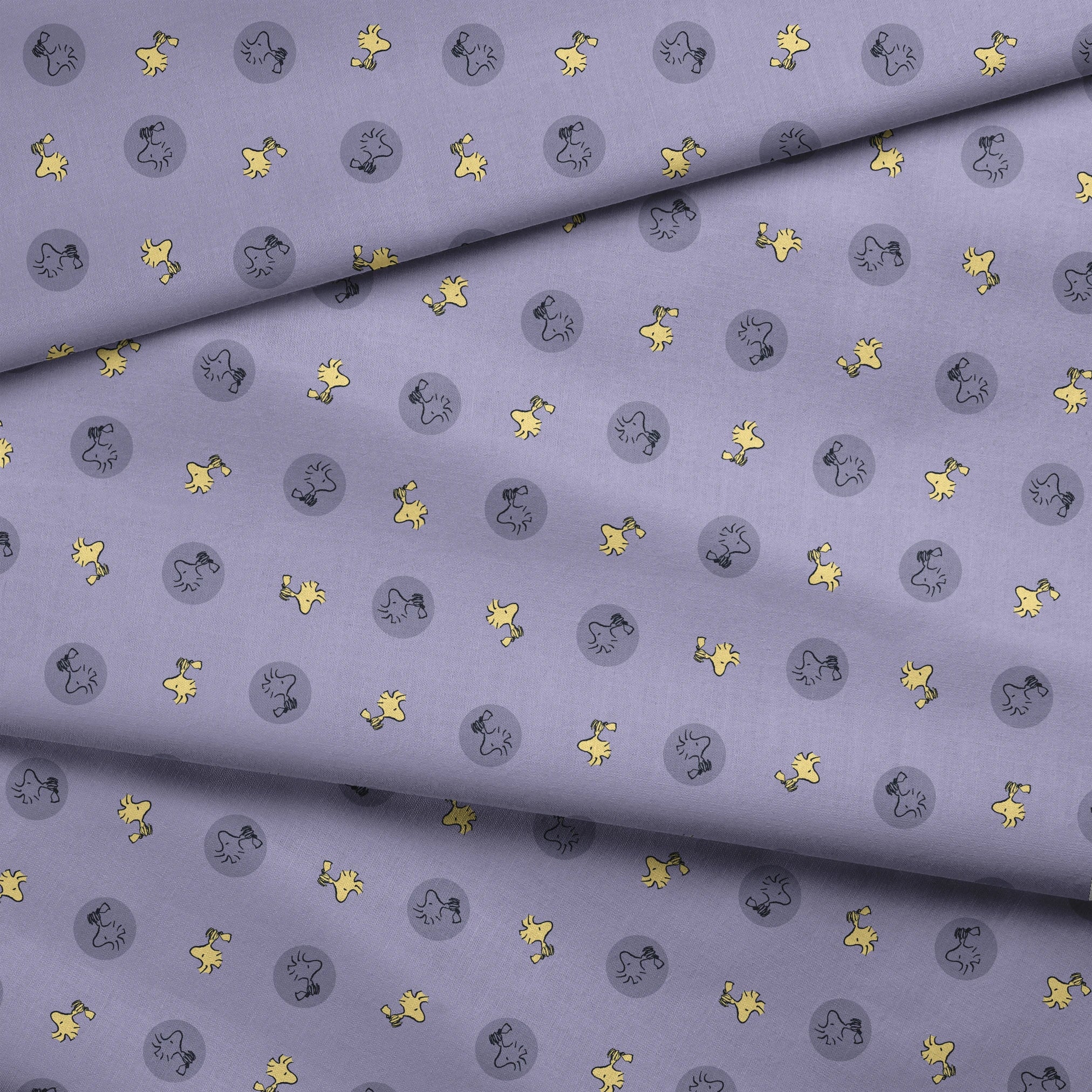Woodstock alternating with gray circular silhouettes on purple background fabric fold mockup