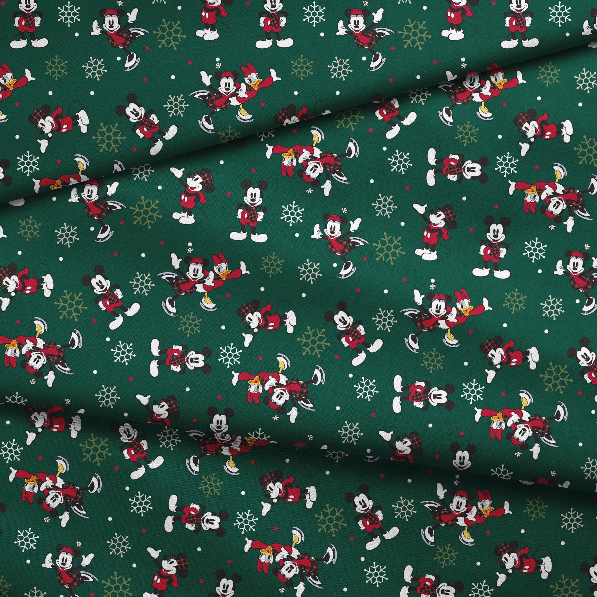 Mickey Mouse Christmas pattern with cartoon characters in winter outfits on green background with snowflakes fabric fold mockup