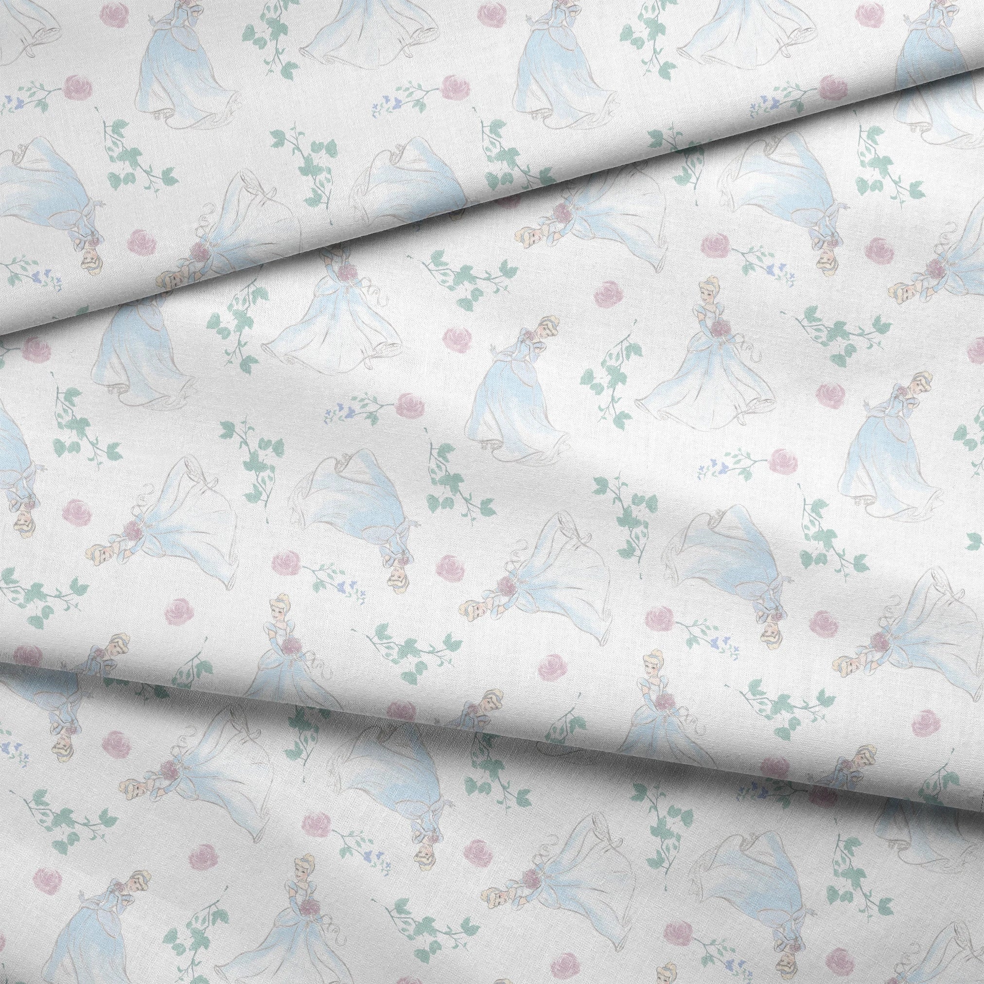 Delicate pattern of flowing blue dresses, pink roses, and mint green foliage on a light background fabric fold mockup