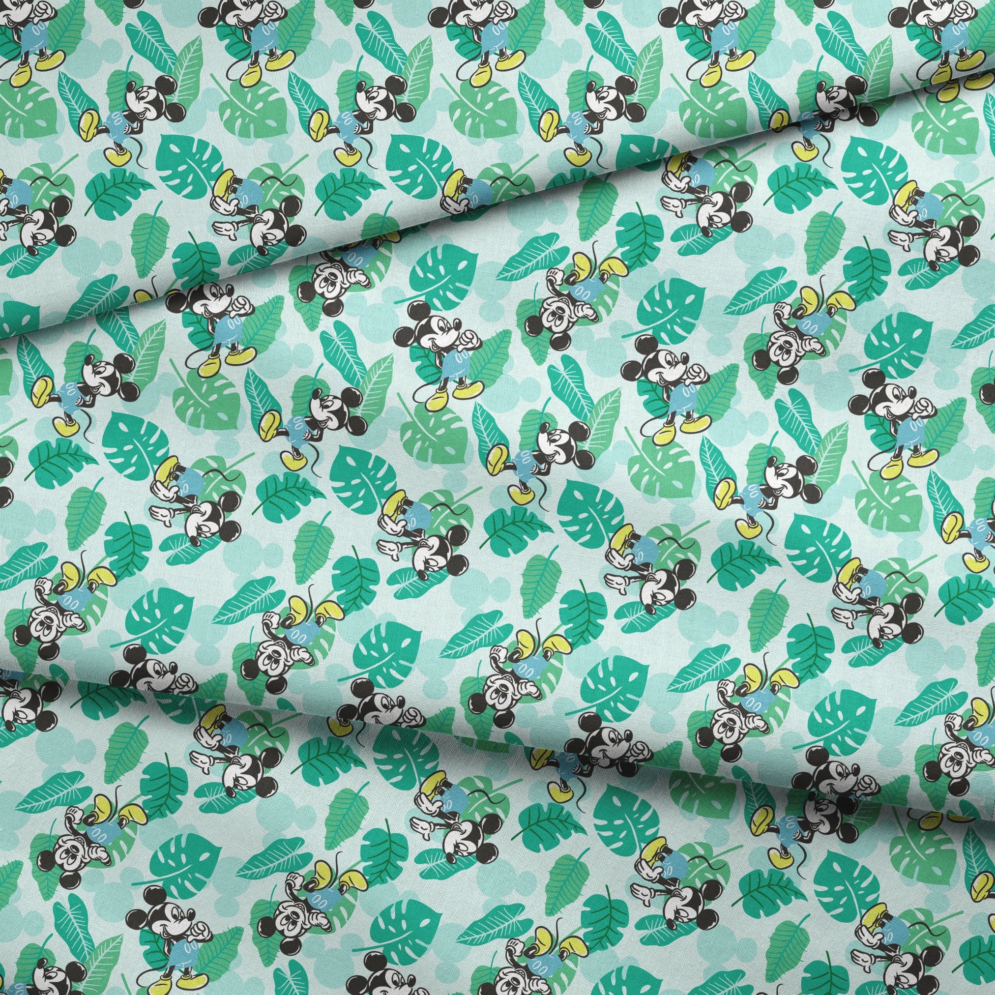 Colorful pattern with cartoon mice characters and tropical green leaves on a light blue background fabric fold mockup