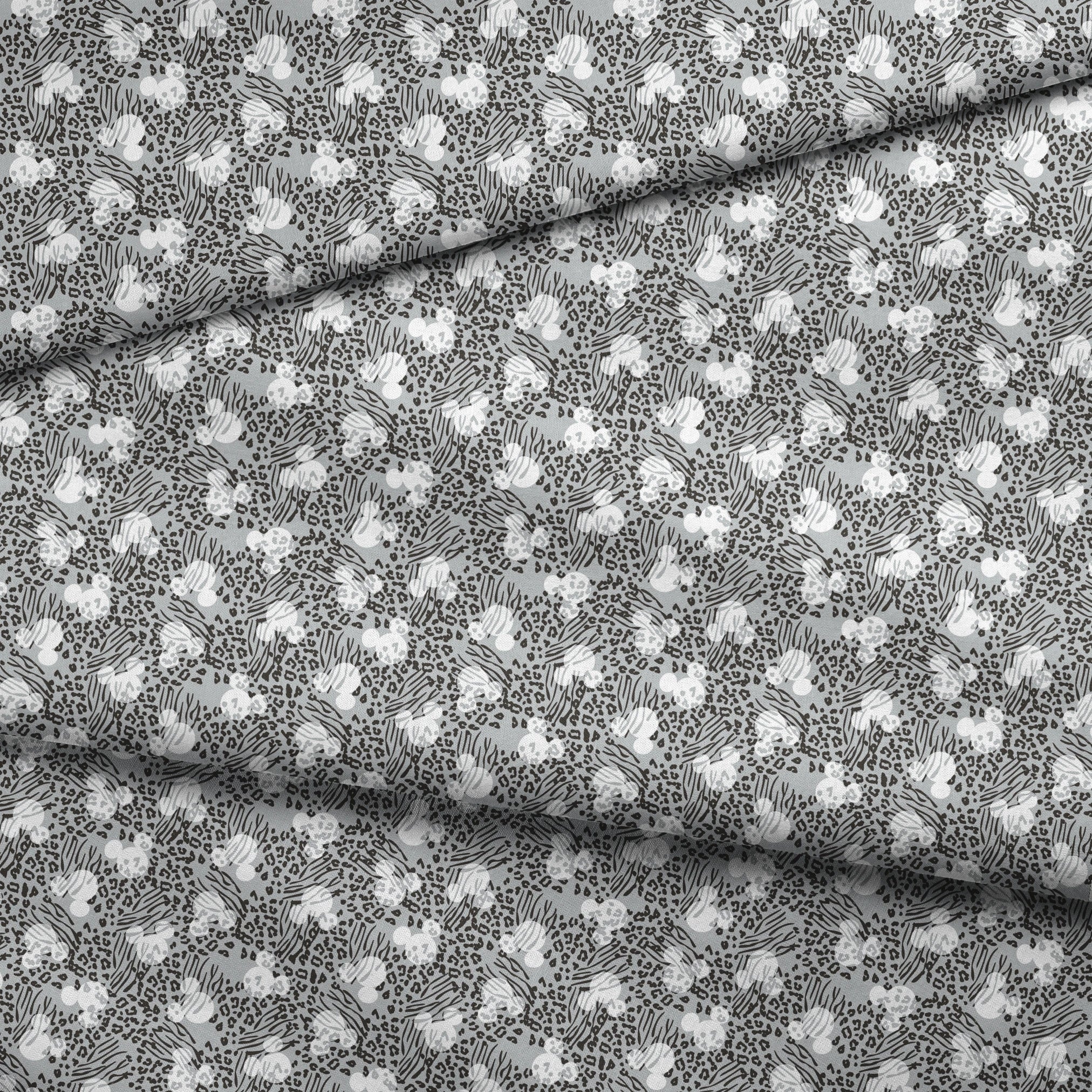 Animal print pattern with zebra stripes and leopard spots in black and white on gray background fabric fold mockup