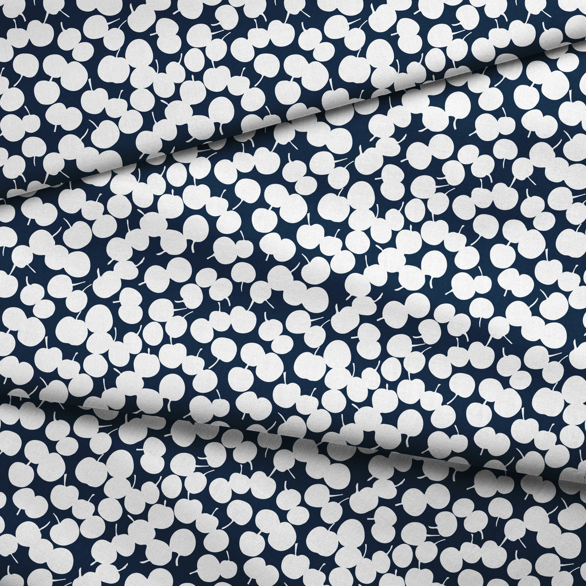 White cherry silhouettes scattered across a deep navy blue background in a playful pattern fabric fold mockup