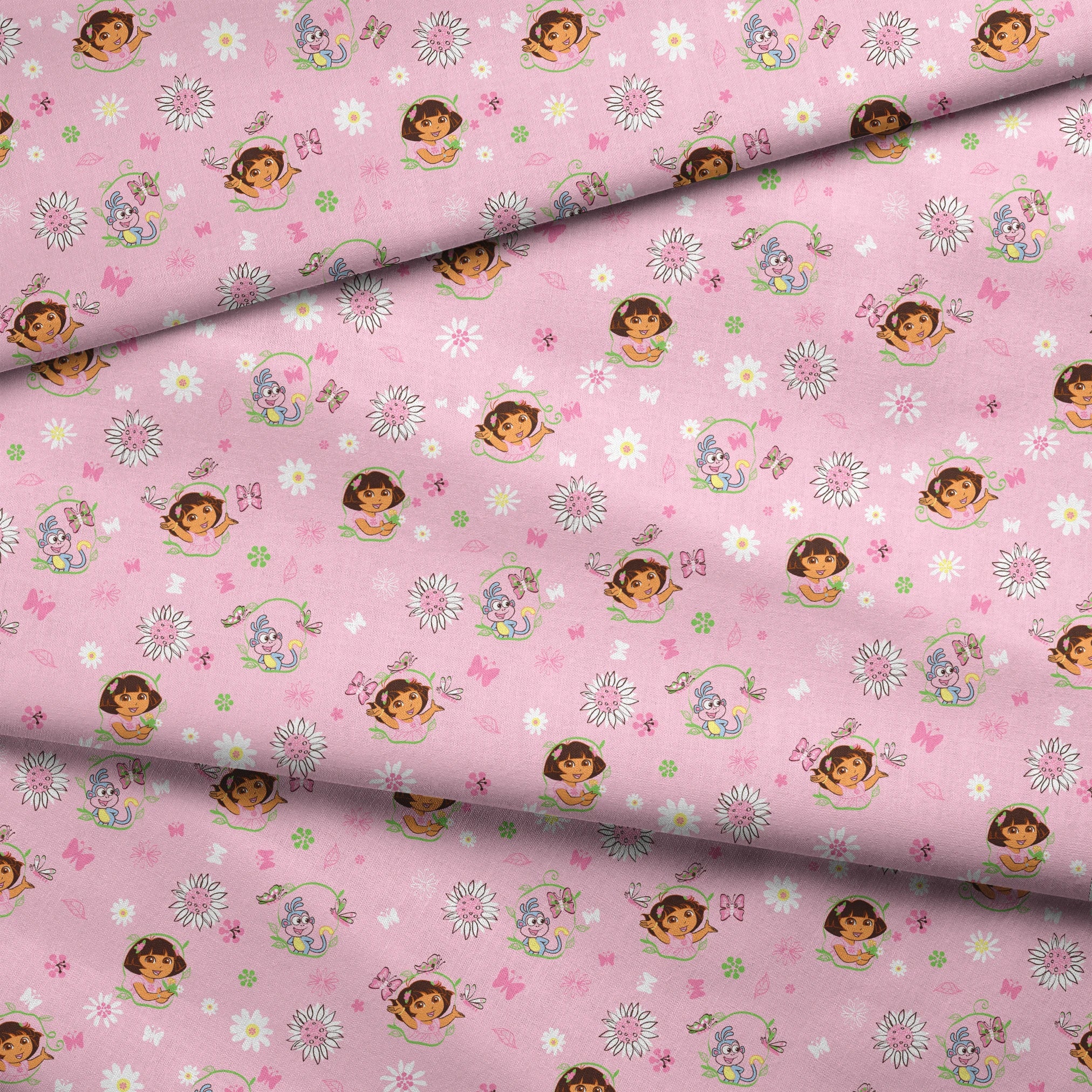 Pink background with Dora the Explorer characters, white daisies and purple butterflies scattered throughout fabric fold mockup