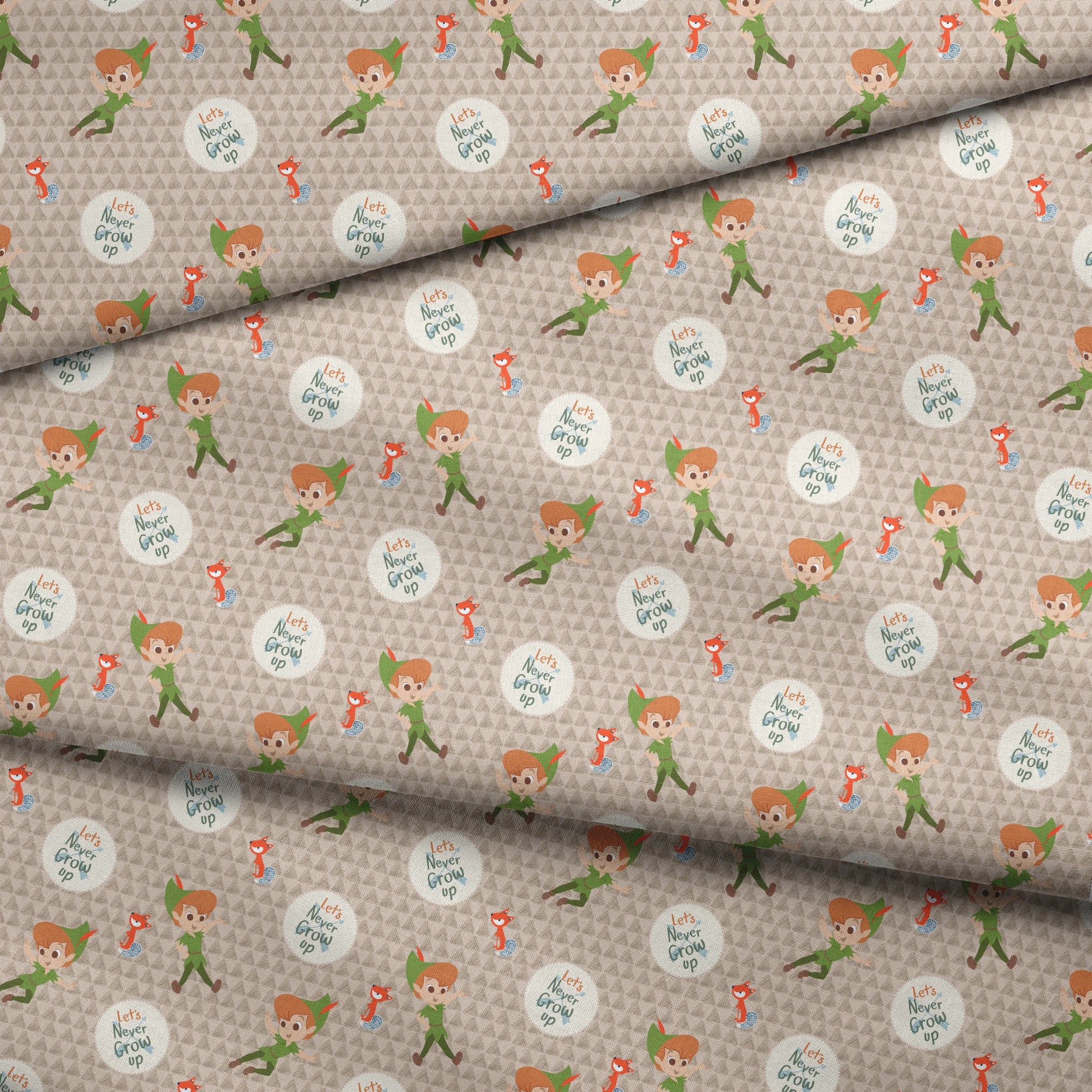 Cartoon pattern featuring Peter Pan character flying, orange foxes, and "Let's Never Grow Up" text on beige background fabric fold mockup
