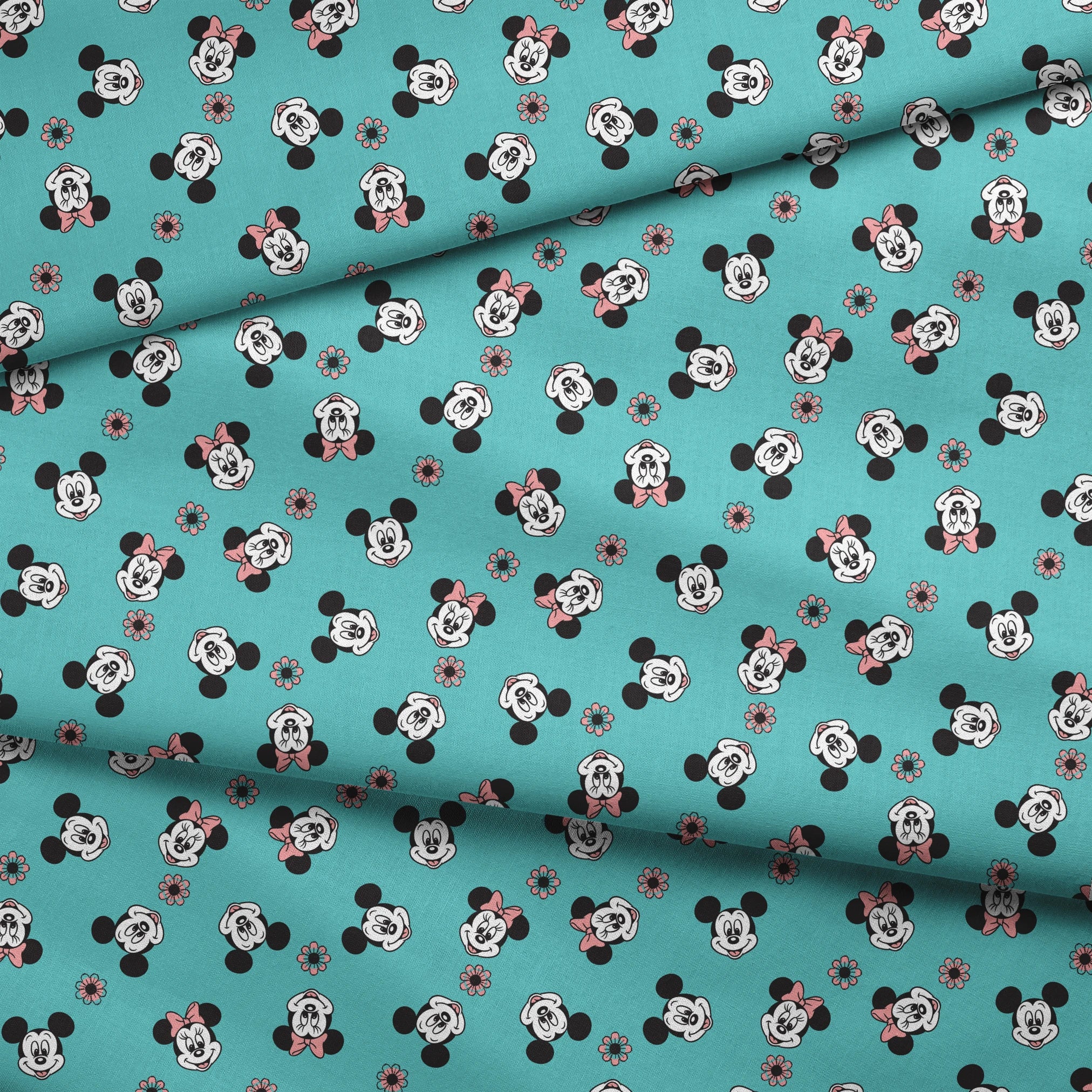 Mickey and Minnie Mouse cartoon faces scattered on turquoise background with small flowers fabric fold mockup
