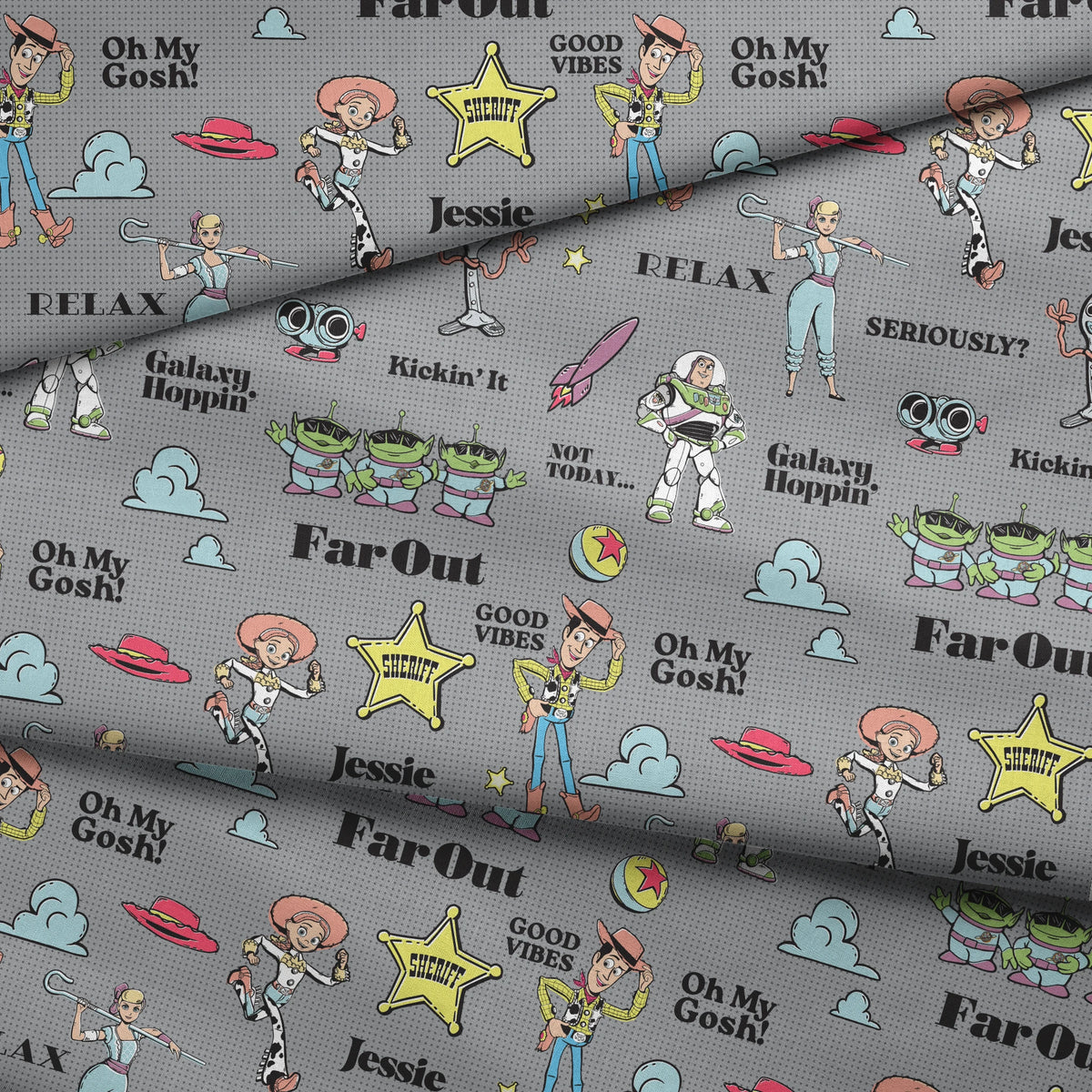 Toy Story character pattern with Buzz, Woody and aliens on gray background with phrases like "Good Vibes" and "Galaxy Hoppin' fabric fold mockup