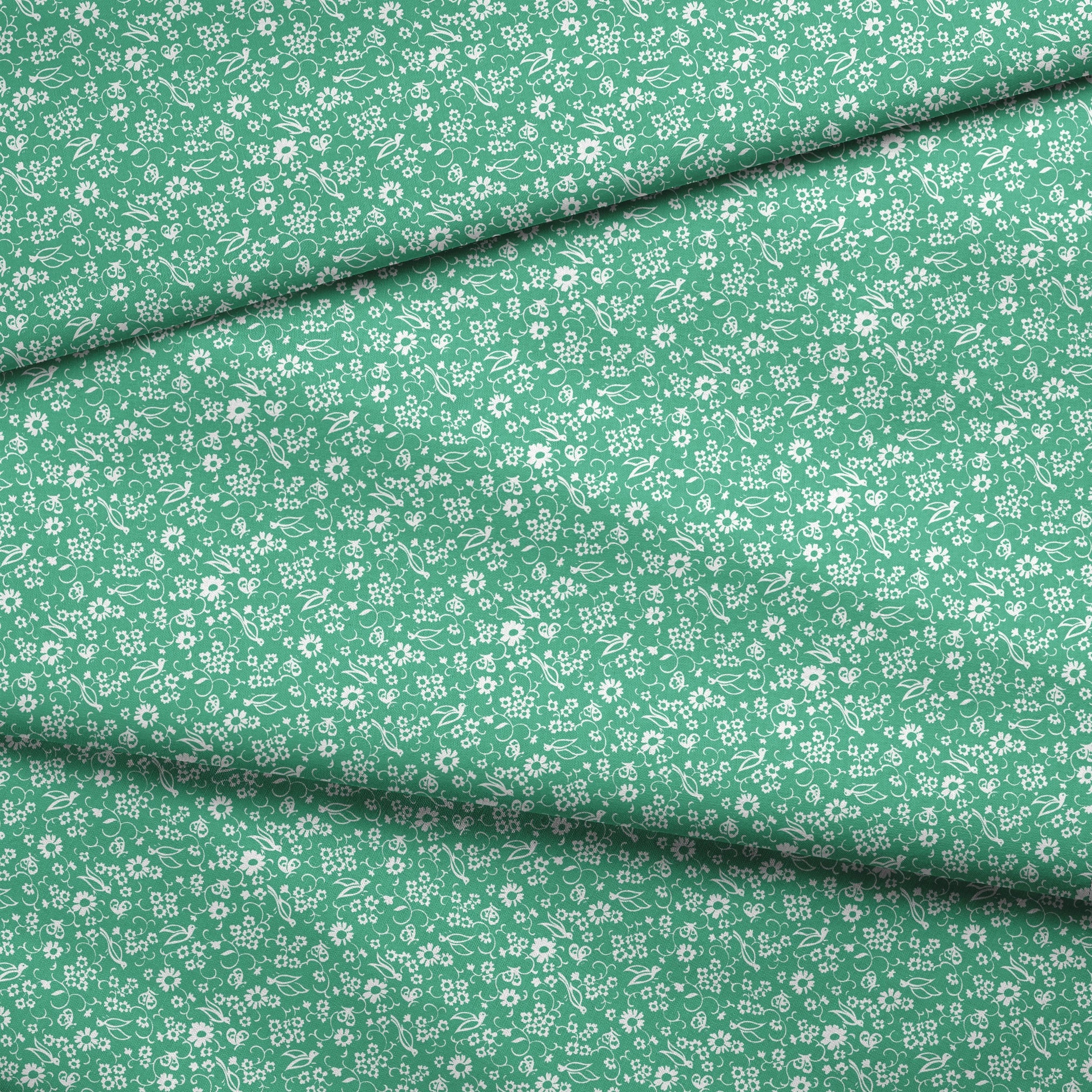 White floral pattern with delicate blooms and leaves on a mint green background fabric fold mockup