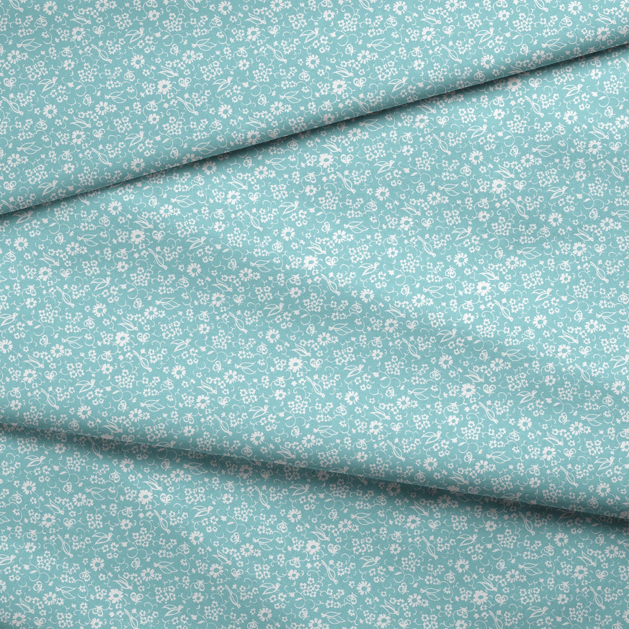 Delicate white floral pattern on a soft turquoise background with swirling leaf motifs fabric fold mockup