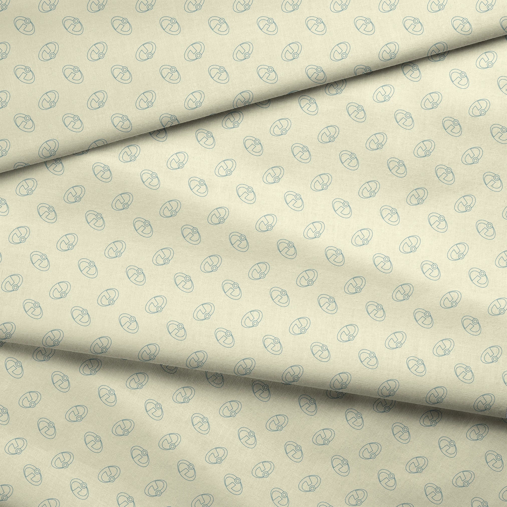 The Incredibles logo forming a repeating pattern on a pale yellow background fabric fold mockup