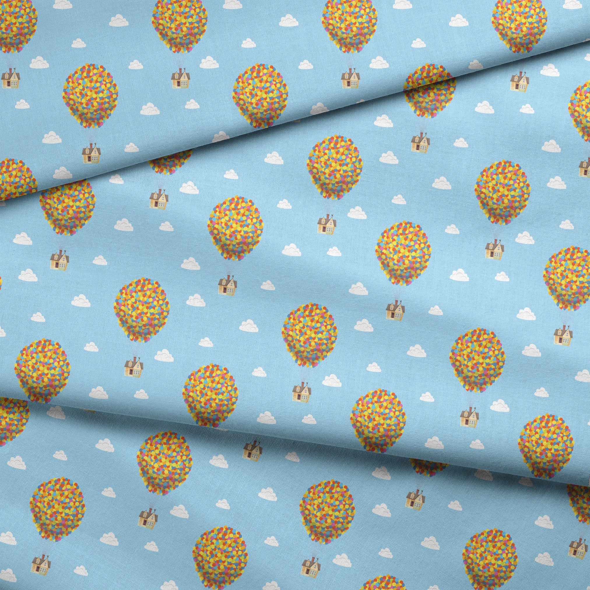 Repeating Up pattern of houses lifted by colorful balloon clusters against a light blue sky with white clouds fabric fold mockup