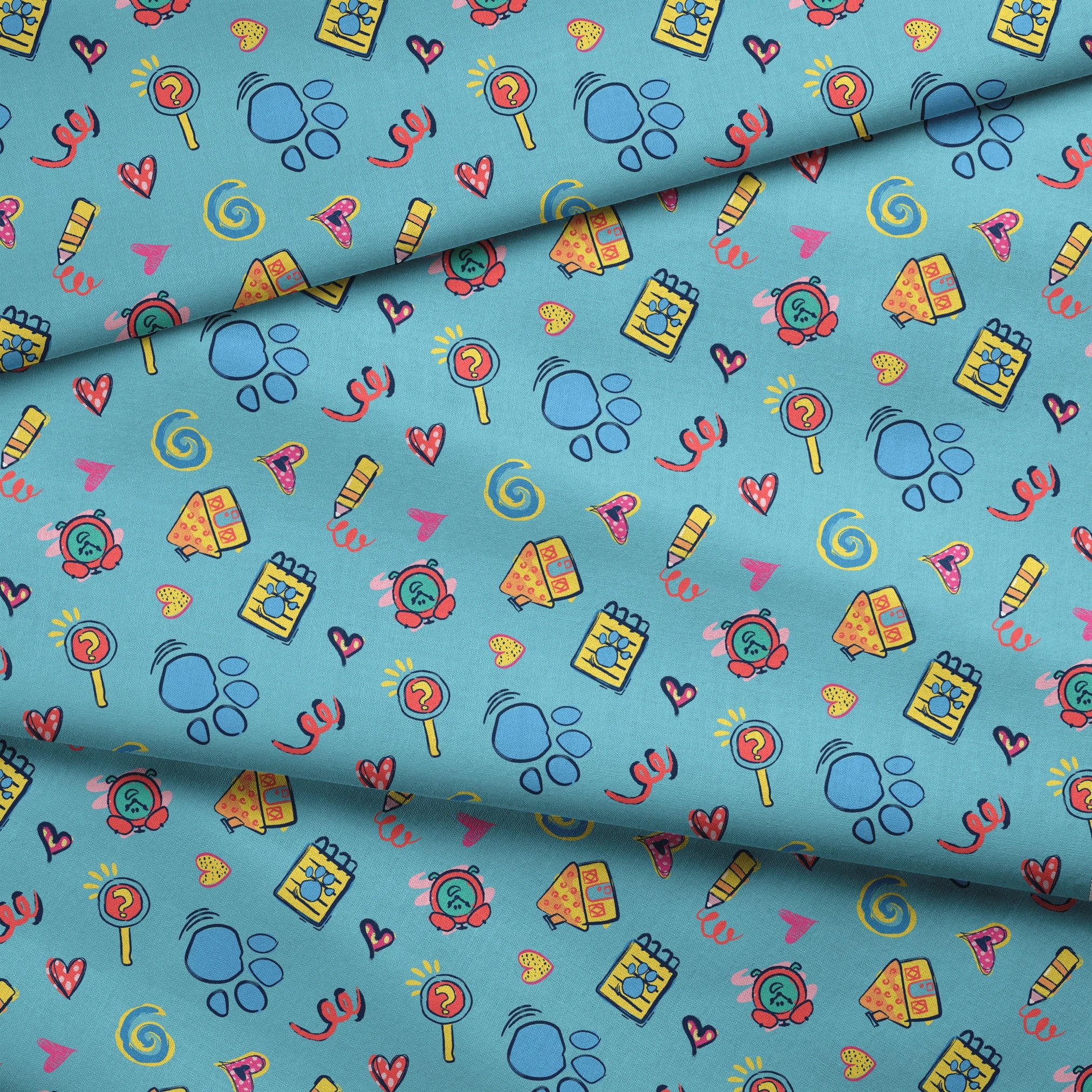 Blue’s Clues doodle-style pattern featuring paw prints, a crayon, spiral notebook, hearts, and magnifying glass on a light blue background. fabric fold mockup