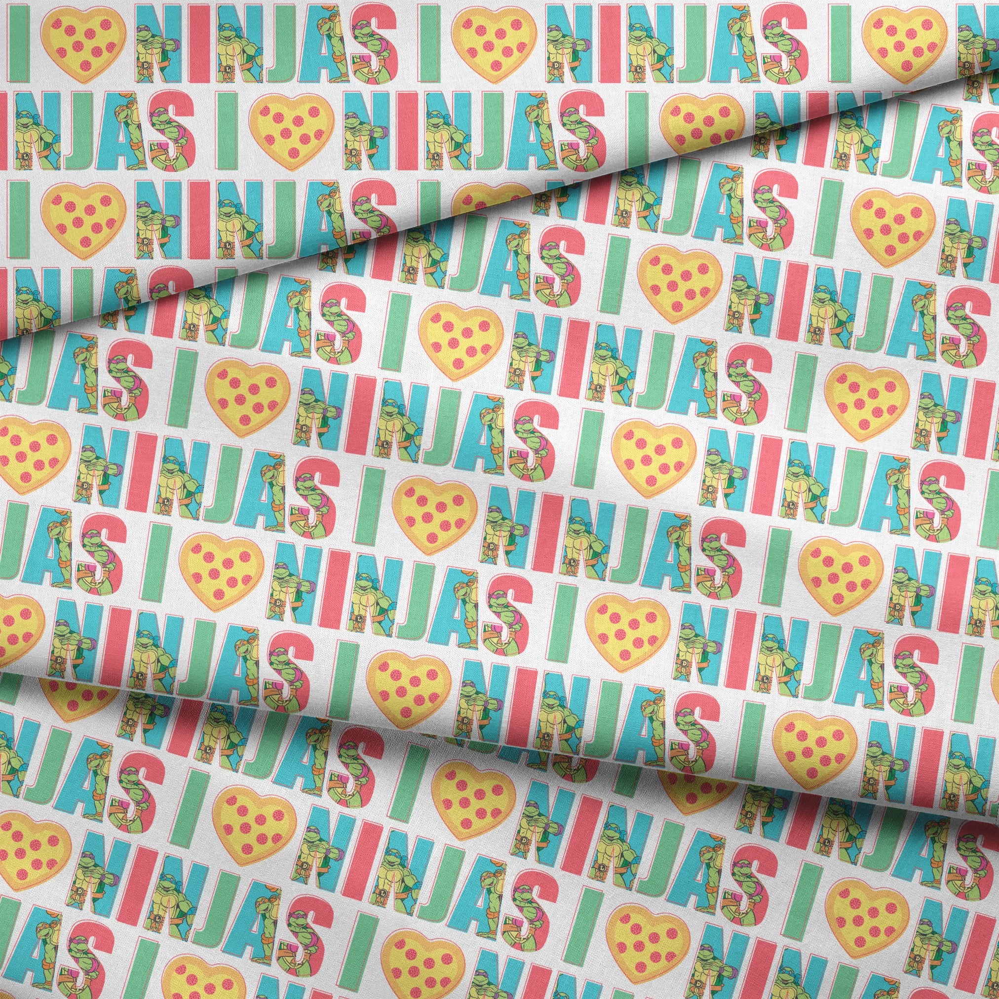 Teenage Mutant Ninja Turtles design with “I heart Ninjas” text with a pizza heart graphic, and Michelangelo and Leonardo in pastel colors. fabric fold mockup