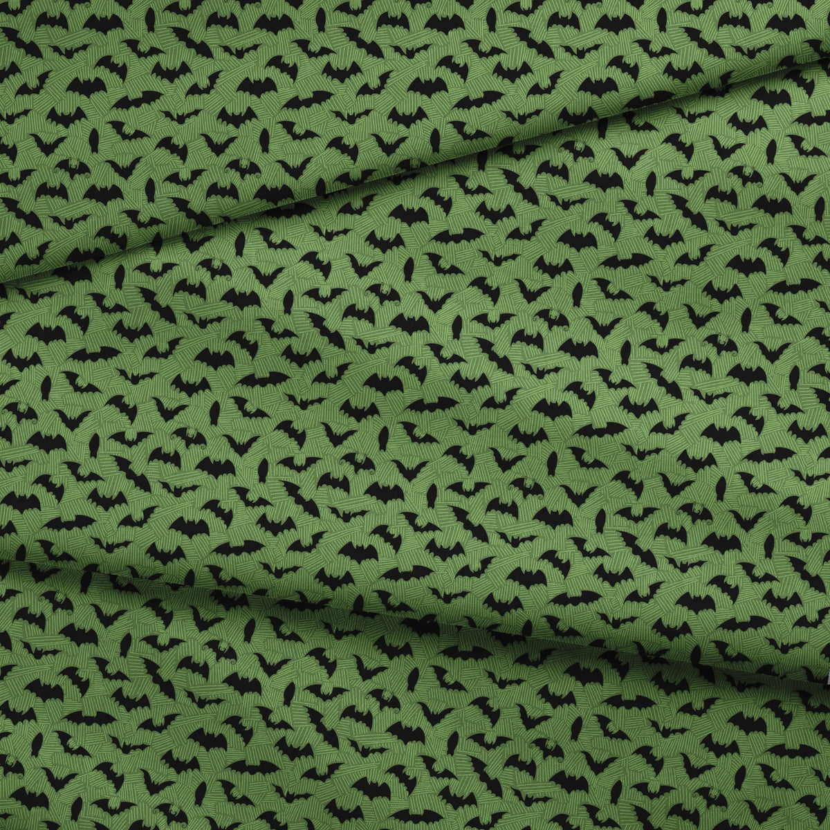 Black bat silhouettes scattered across a green textured background with zigzag pattern fabric fold mockup