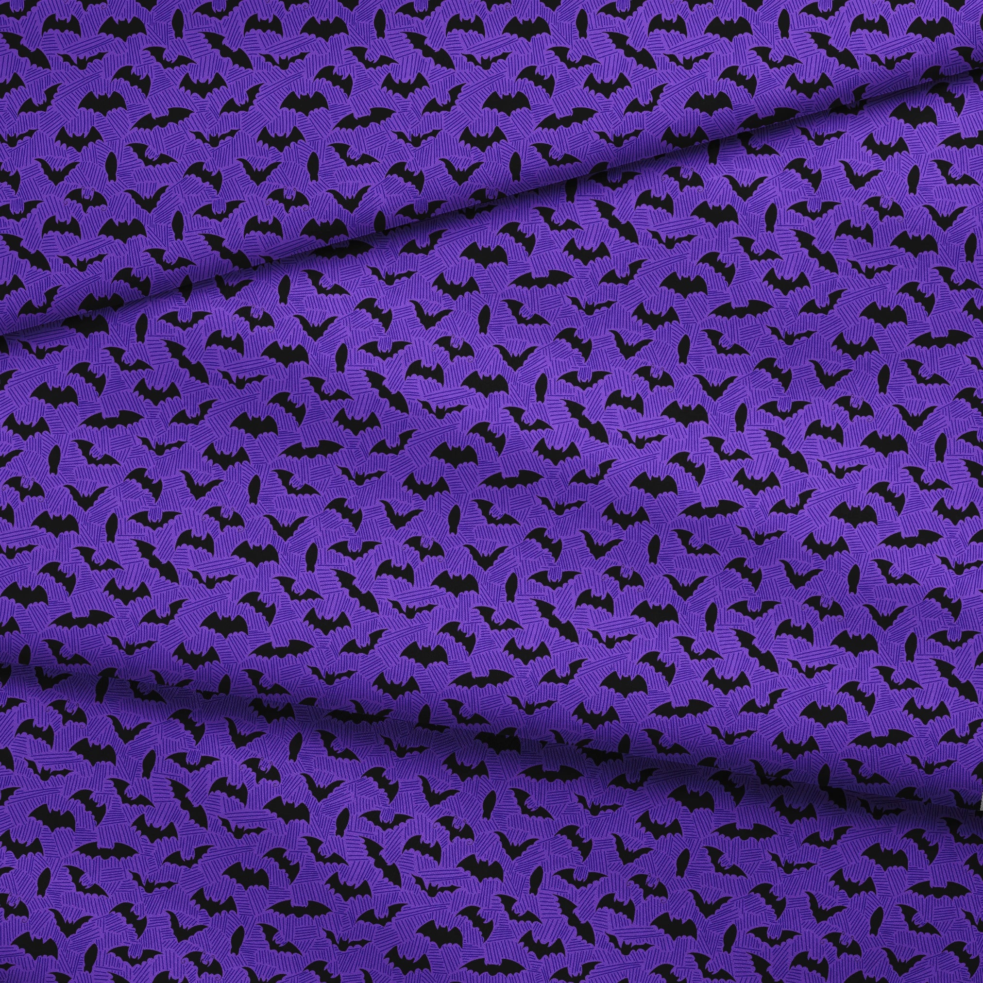 Black bat silhouettes scattered over purple zigzag background, Halloween-themed pattern fabric fold mockup
