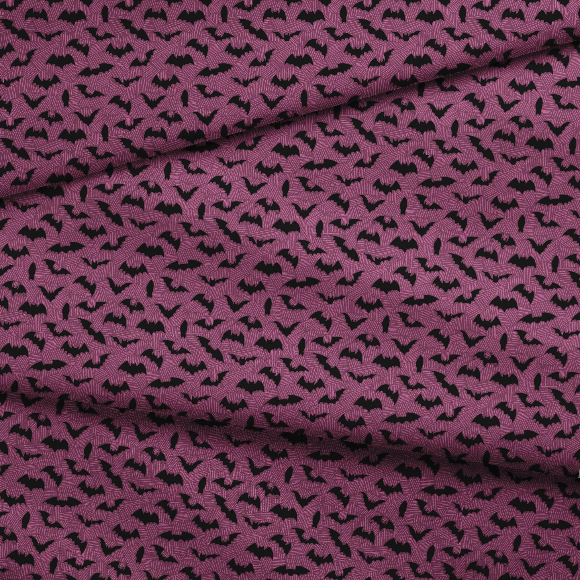 Black bat silhouettes scattered across a purple background with swirling line pattern fabric fold mockup