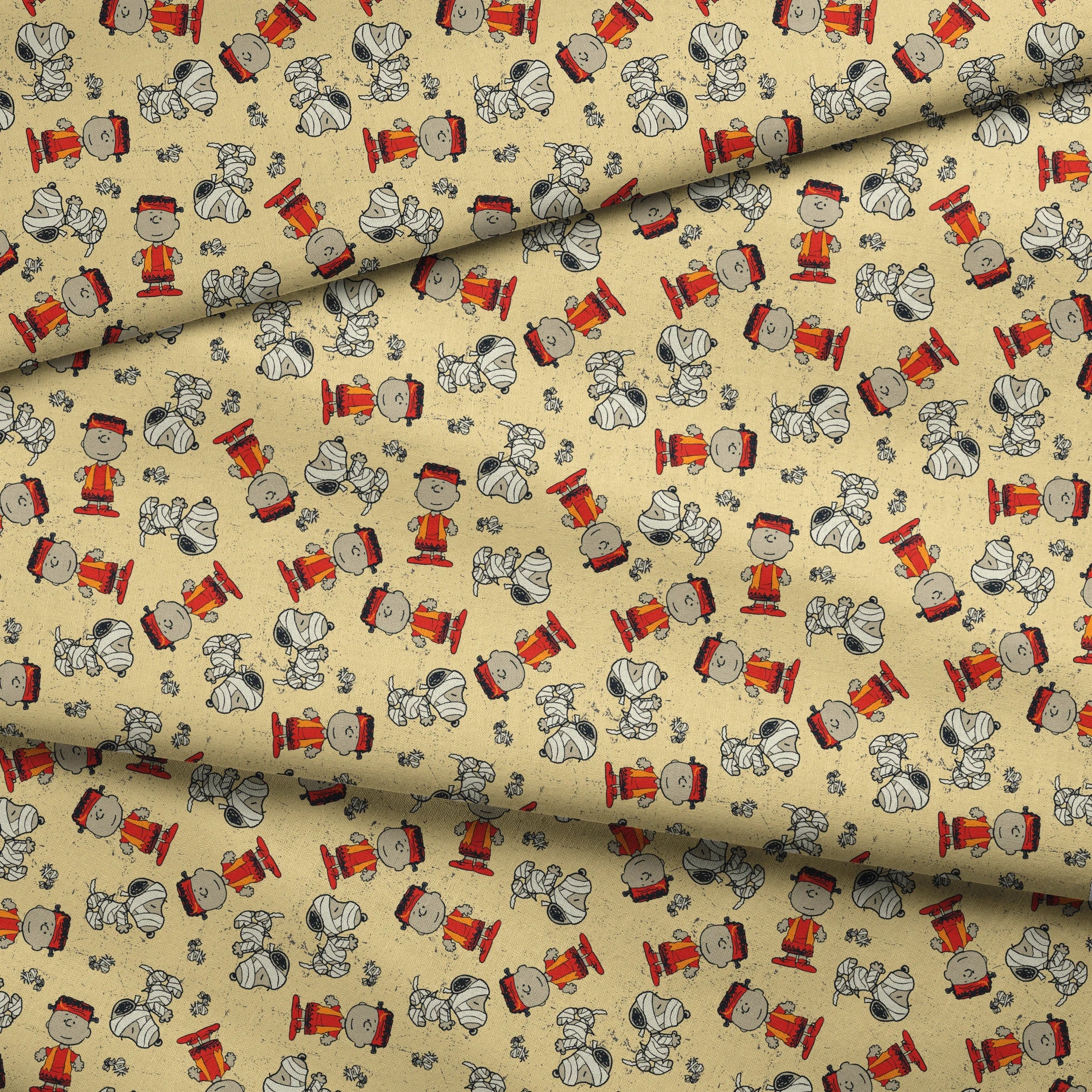 Peanuts characters pattern with Charlie Brown and Snoopy in halloween attire on beige background fabric fold mockup