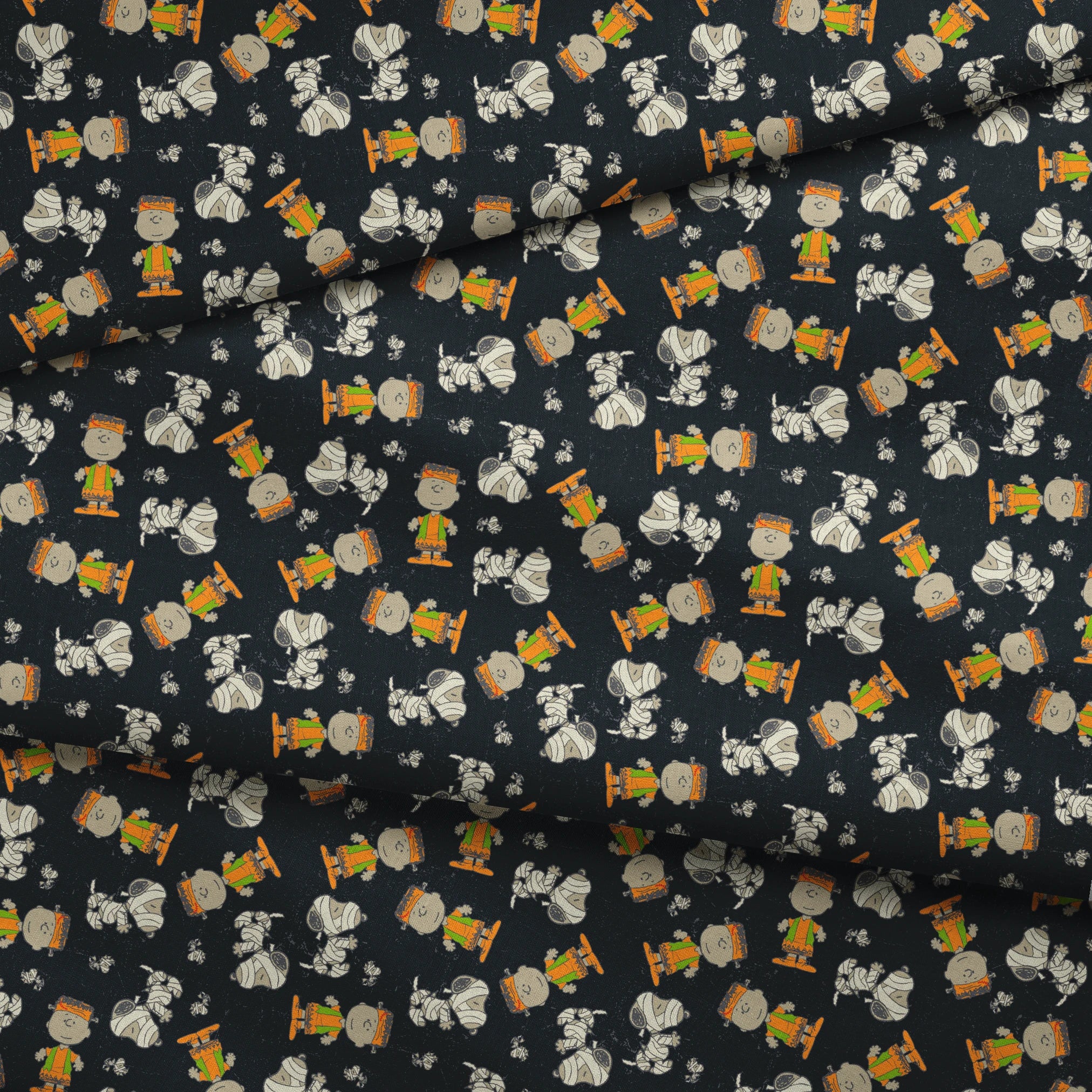 Peanuts characters pattern on black background featuring Snoopy and Charlie Brown in fall outfits fabric fold mockup