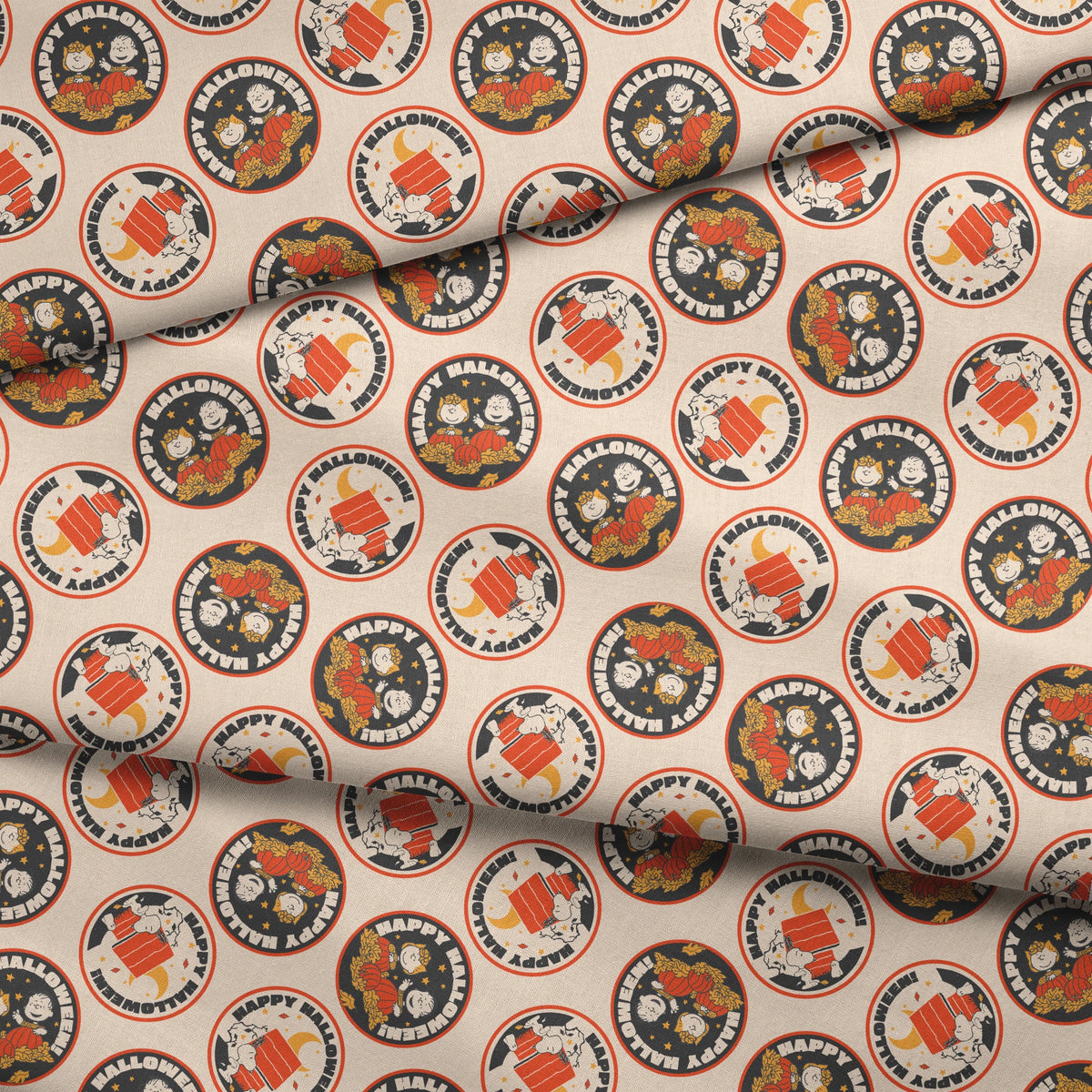 Peanuts Halloween pattern with circular badges featuring characters and "Happy Halloween" text on beige background fabric fold mockup