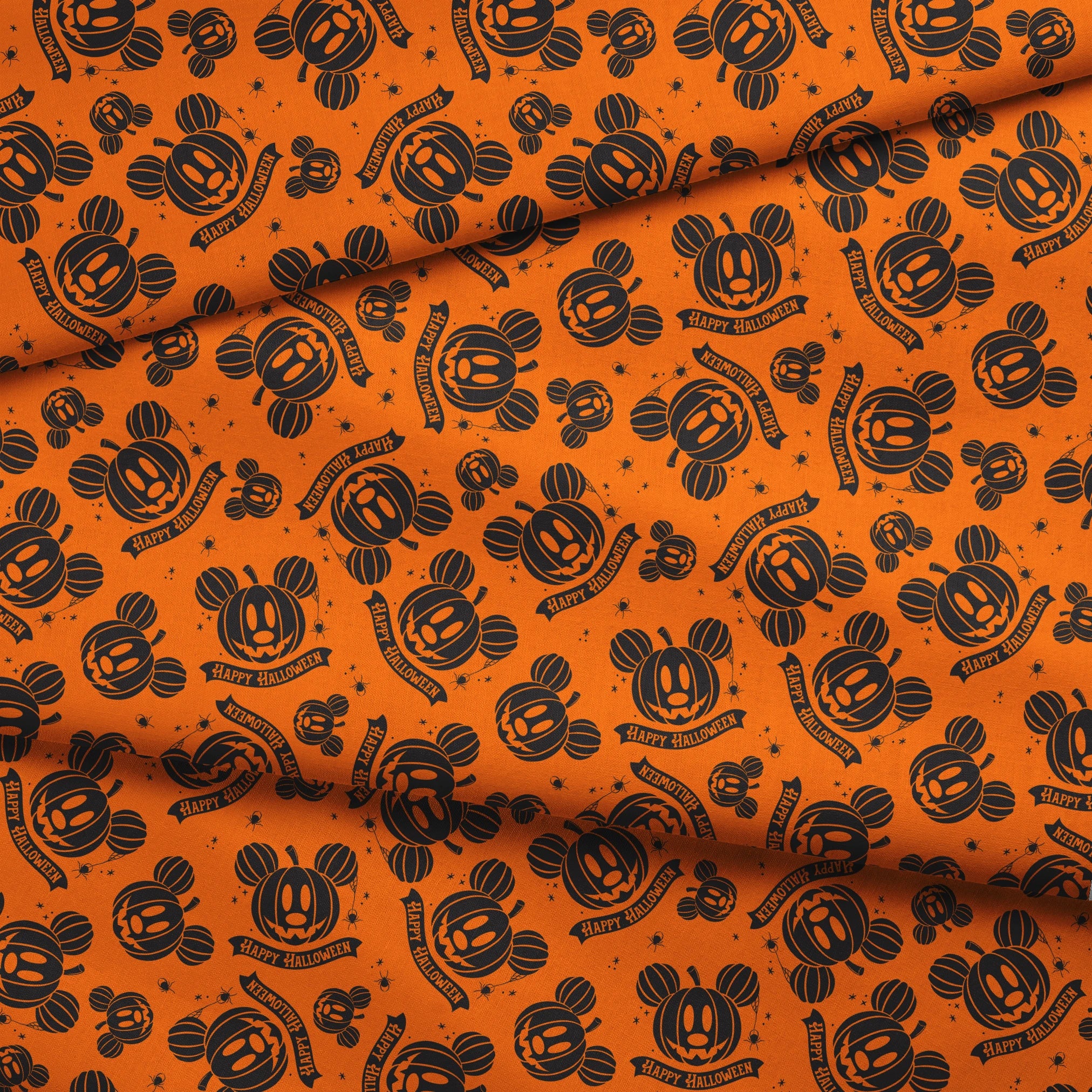 Halloween pattern with Disney-inspired jack-o'-lantern pumpkins and "Happy Halloween" text on bright orange background fabric fold mockup