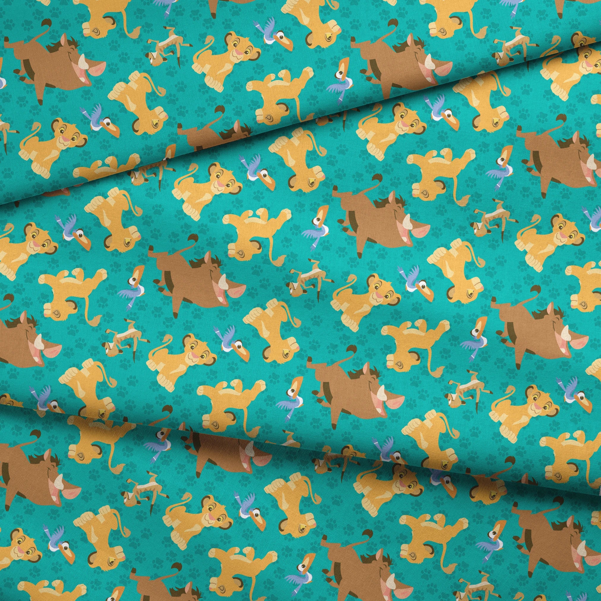 Cartoon Lion King characters pattern with Simba, Pumbaa and others on turquoise paw print background fabric fold mockup